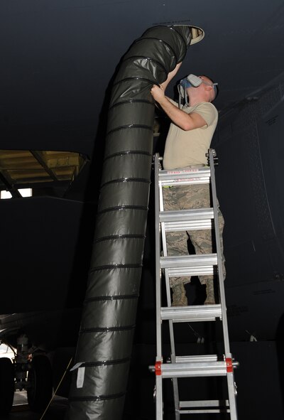Staff Sgt. Daniel Palmer, 2nd Maintenance Squadron fuels systems, places a ventilation dock inside a B-52H Stratofortress on Barksdale Air Force Base, La., Feb. 8. When a fuel tank needs repairs, sealant is placed on it to prevent leaking. The ventilation dock transfers warm air to the fuels systems to make the sealant harden faster. (U.S. Air Force photo/Airman 1st Class Benjamin Gonsier)
