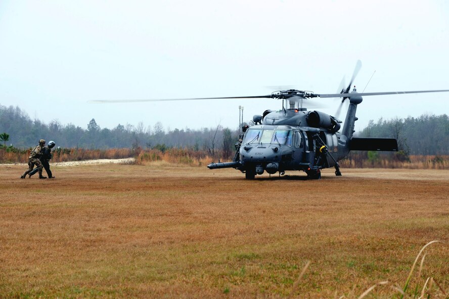 An HH-60G Pave Hawk from the 41st Rescue Squadron waits as pararescuemen from the 38th Rescue Squadron rescue a downed pilot during a combat search and rescue demonstration at Moody Air Force Base, Ga., Feb. 7, 2013. National Geographic’s new television series, “Inside Combat Rescue,” provides a firsthand look at what rescue Airmen deal with in combat environments. (U.S. Air Force photo by Airman 1st Class Olivia Bumpers/Released)
