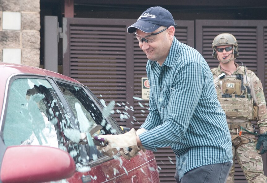 Christopher Albert participates with the 38th Rescue Squadron Guardian Angel Pararescue jumpers participate in a breach and rescue demonstration at Moody Air Force Base Ga., Feb 7, 2013. The PJs demonstrated the capabilities and tools on how they would rescue an individual trapped in a car. (U.S. Air Force Photo by Airman Paul Francis/Released)