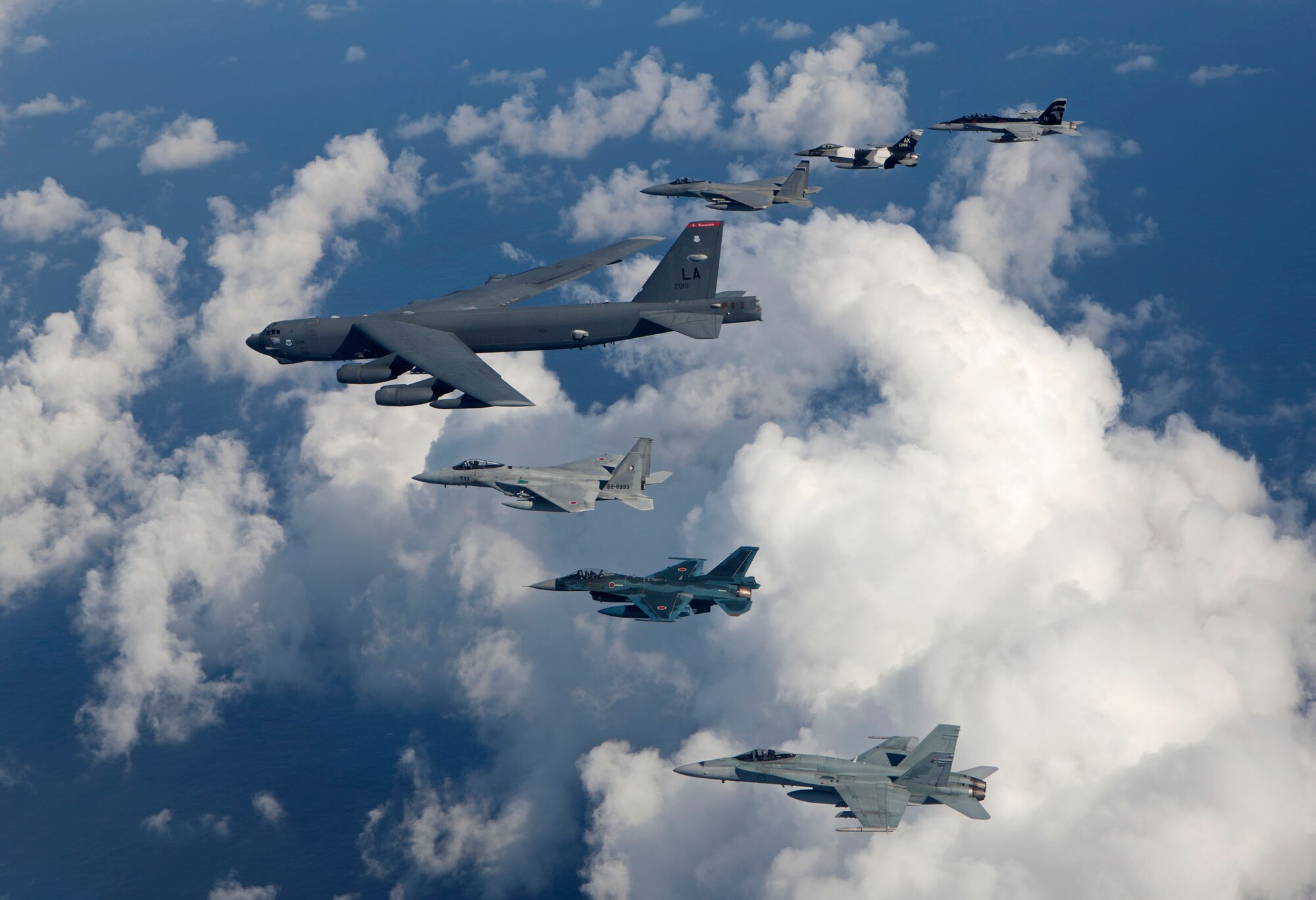 Aircraft from the U.S. Air Force, U.S. Navy, Japan Air Self-Defense Force, and Royal Australian Air Force fly in formation over the Pacific Ocean in support of exercise Cope North 2013, Andersen Air Force Base, Guam, Feb. 5, 2013. During this event, the aviators trained on war-fighting integration tactics. Cope North is a multilateral aerial and humanitarian assistance and disaster relief exercise, held annually, designed to increase the combat readiness and interoperability of the U.S. military, JASDF, and RAAF. (Courtesy photo/Jim Haseltine/Released)