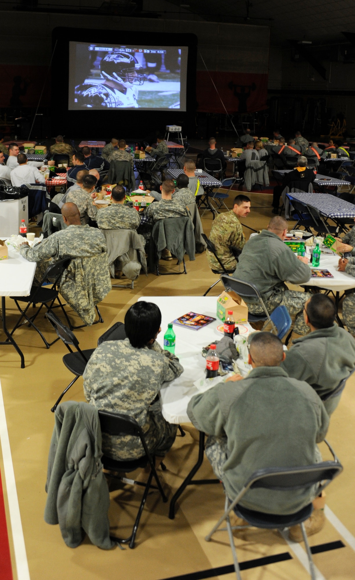Mobilizing and demobilizing service members watch the Super Bowl Feb. 4, 2013, at Griffith Field House at Joint Base McGuire-Dix-Lakehurst, N.J. The service members who attended were also treated to free dinners. The event is targeted toward mobilizing and demobilizing service members to boost morale and ensure comprehensive service member fitness as they return from or head out on their deployments. (U.S. Air Force photo by 2nd Lt. Alexis McGee/Released)