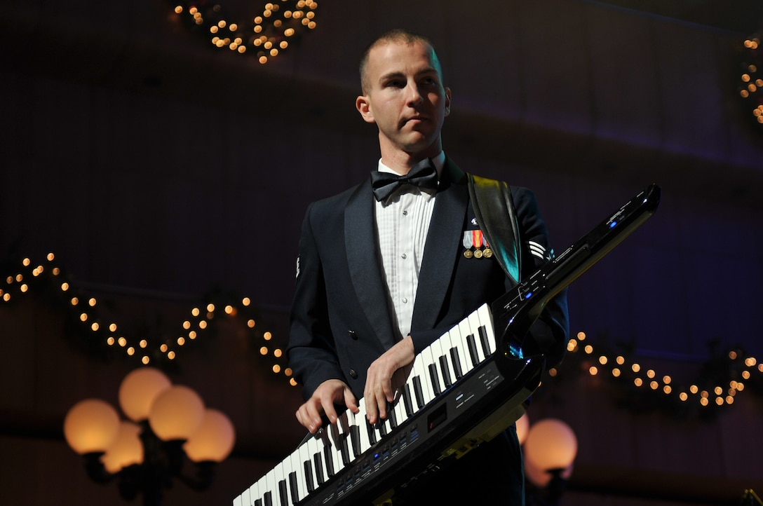 Senior Airman Ryan Rager performs "A Christmas Rock Medley" with Night Wing