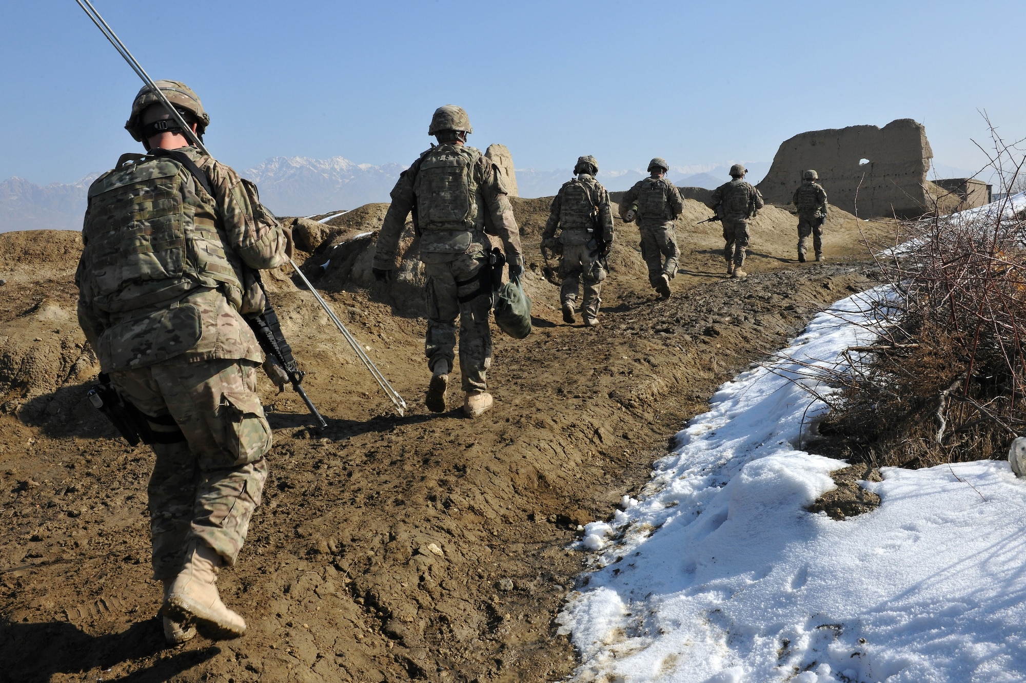 Members of the 777th Expeditionary Prime BEEF Squadron and the 755th Expeditionary Security Forces Squadron travel to help fix the broken water wells in villages near Bagram Airfield, Afghanistan, Jan. 26, 2013. These Airmen traveled by foot in small groups over dirt roads and had to carry all their tools and equipment by hand along with their weapons. (U.S. Air Force photo/Senior Airman Chris Willis)
