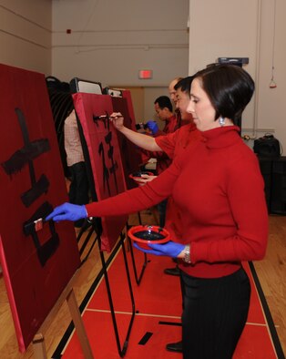U.S. Air Force Lt. Col. Christine Mau, 428th Fighter Squadron director of operations, along with fellow squadron members paint traditional Chinese characters as part of the squadron’s Chinese New Year celebration Feb. 7, 2013, at Mountain Home Air Force Base, Idaho. Throughout the evening there were games, prize raffles and musical performances. Personnel from MHAFB had the unique opportunity to attend the celebration and enjoy the traditional festivities. (U.S. Air Force photo/Senior Airman Benjamin Sutton) 