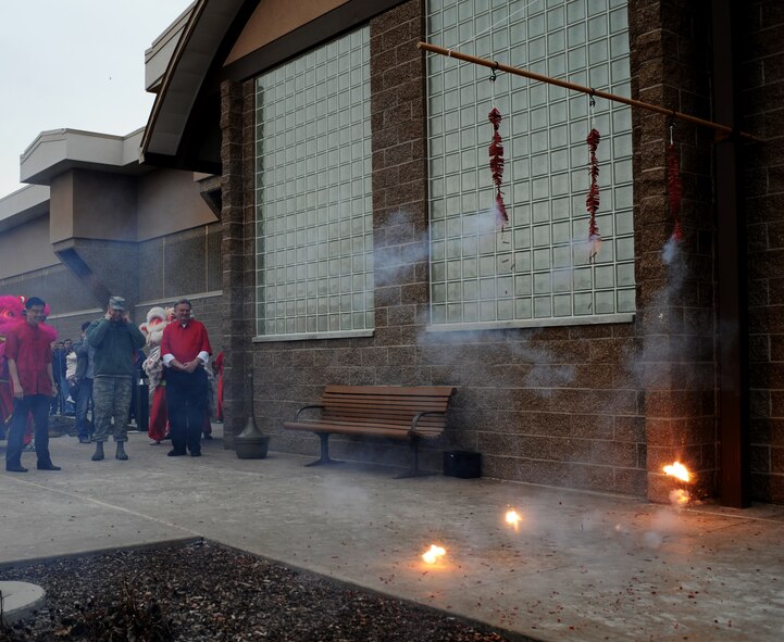 From left, Republic of Singapore Air Force Lt. Col. Jin Kiat Tan, 428th Fighter Squadron senior ranking officer, U.S. Air Force Col. Chris Short, 366th Fighter Wing commander, and Mr. Tom Rist, mayor of Mountain Home, Idaho, watch while fireworks explode signifying the start of the 428th FS Chinese New Year celebration Feb. 7, 2013, at Mountain Home Air Force Base, Idaho. The celebration was held inside the ballroom of the Gunfighter Service Center to accommodate the more than 300 personnel in attendance. (U.S. Air Force photo/Senior Airman Benjamin Sutton)