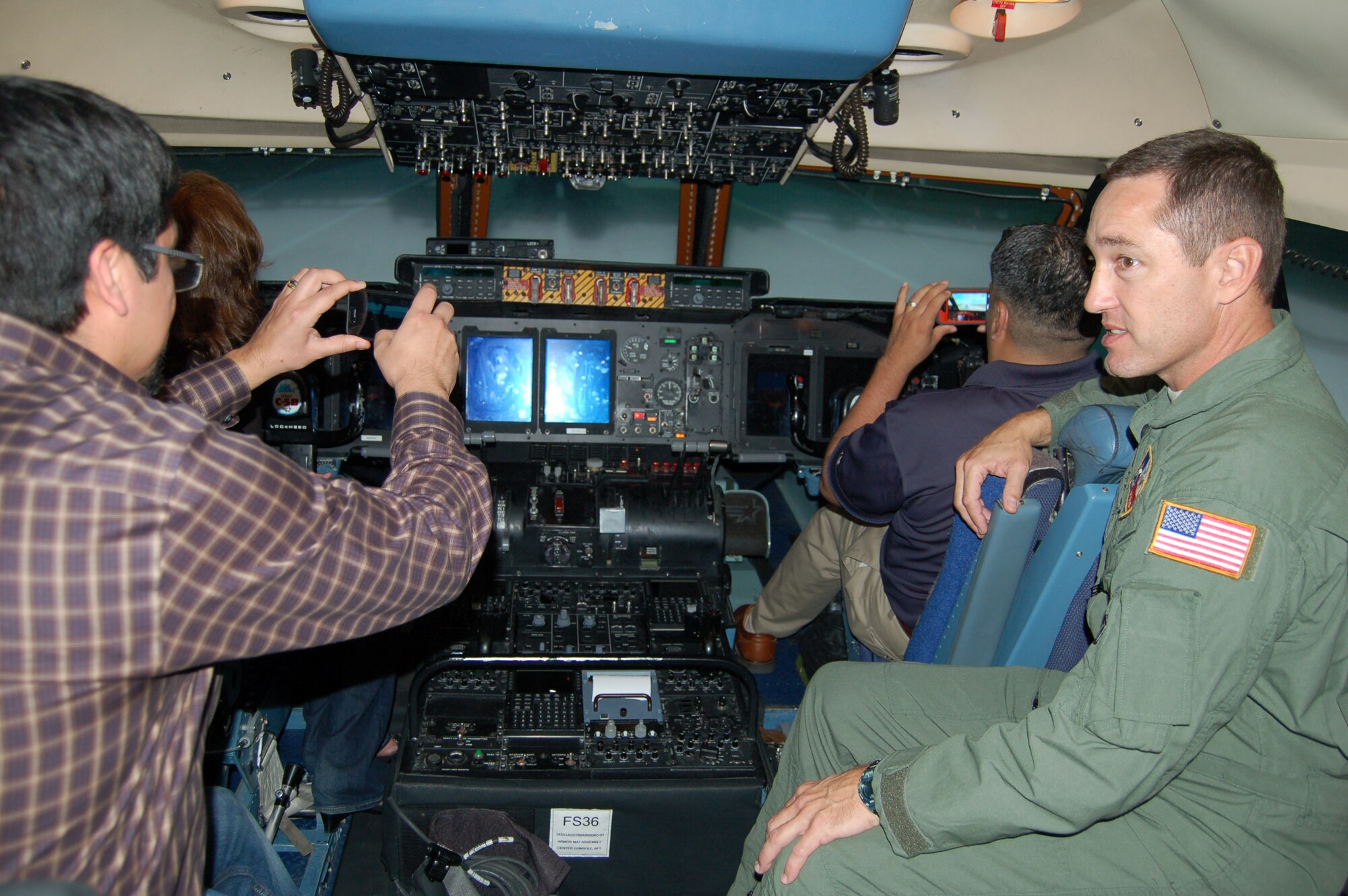 Master Sgt. Tony Wilks, deputy superintendent of the 433rd Operations Groups' 733rd Training Squadron, explains the various scenarios utilized by the 733 TRS's C-5A Galaxy simulator to visitors from insurance giant USAA's Mortgage Division.  The 733 rd TRS is a formal C-5 training unit that trains all C-5 aircrews and students and is located at the 433rd Airlift Wing, a C-5 equipped, Air Force Reserve unit located at Joint Base San Antonio-Lackland.  USAA employees routinely visit the "Alamo Wing" and other local military installations to learn about their diverse missions so that they may better serve their customers, most of whom are either presently serving in or are retired from the military services. (U.S. Air Force photo by Elsa Martinez)
