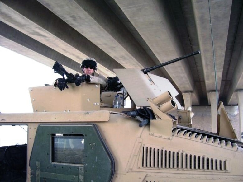 Tech. Sgt. Francis Woznick, 366th Security Forces Squadron, poses in a Humvee turret prior to a security convoy in Iraq. The Mahdi Army, also known as the Mahdi Militia or Jaish al-Mahdi, were the biggest threat to Woznick’s team, and he remembers well the first time those terrorists killed three of his British comrades, a mere three weeks after he arrived in country. (Courtesy photo)