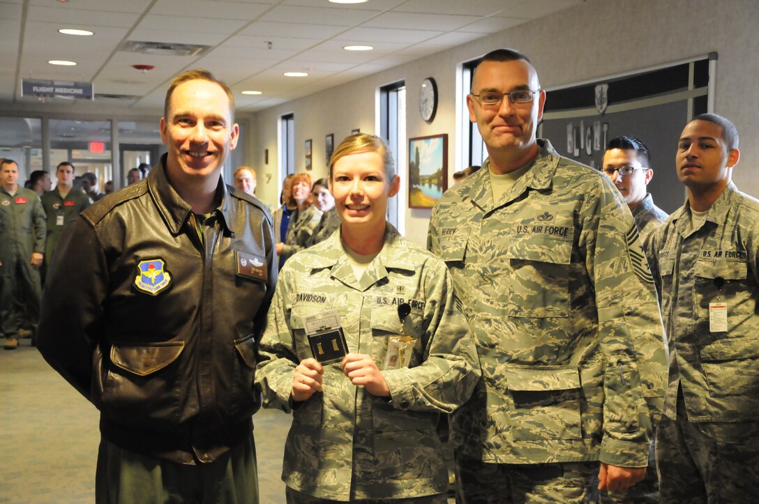 Col. Tom Murphy, 47th Flying Training Wing commander, and Chief Master Sgt. Garry Berry, 47th FTW command chief, presents a pair of Lieutenant bars to Senior Airman Kathleen Davidson, 47th Medical Group medical technician, in front of the medical staff in the Laughlin Clinic at Laughlin Air Force Base, Texas, Feb. 1, 2013. Davidson earned a scholarship through the Scholarships for Outstanding Airman to Reserve Officer Training Corps, where she will pursue a nursing degree and a commission into the Air Force. (U.S. Air Force photo/2nd Lt. David Tart)