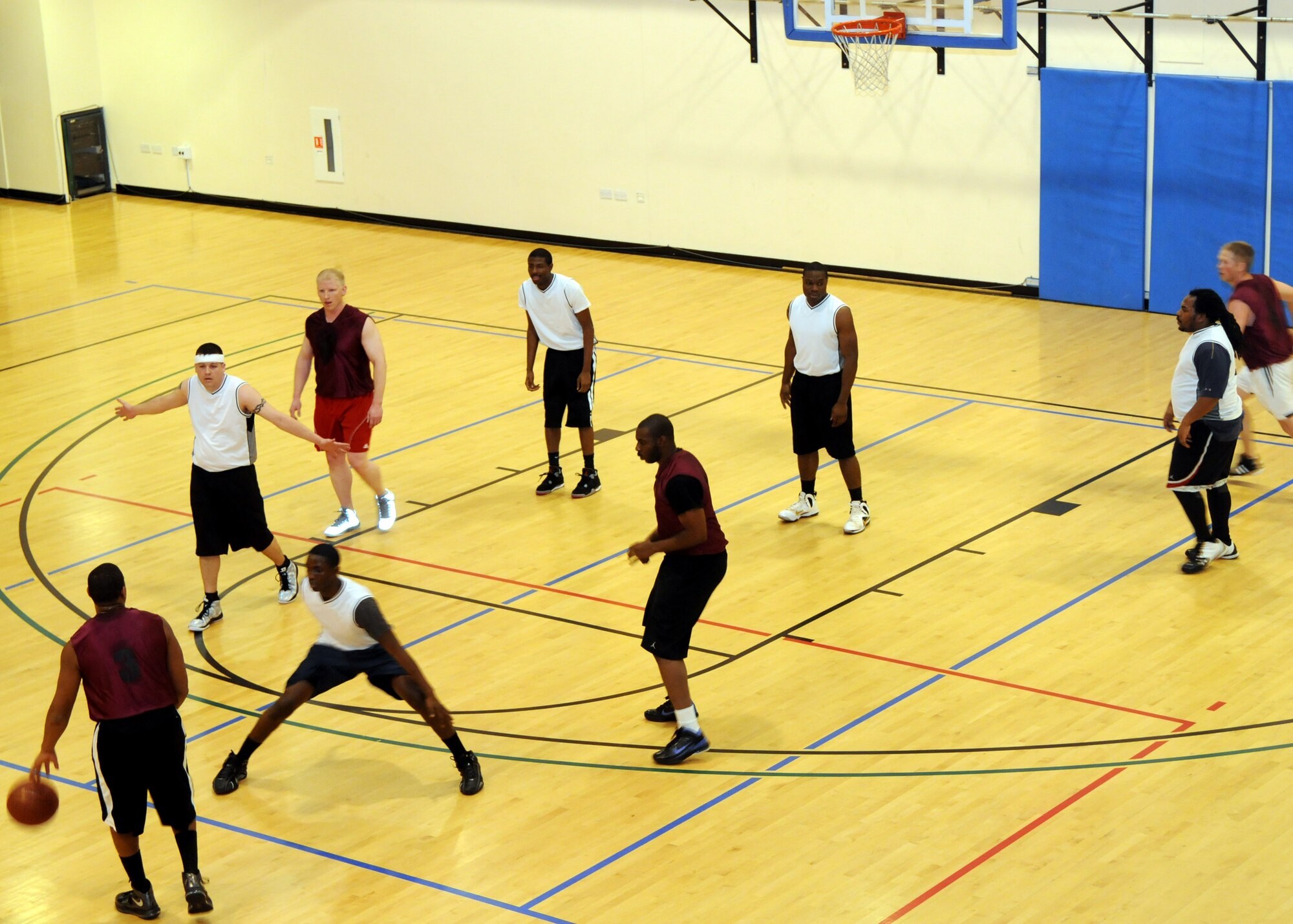 Players from the 488th Intelligence Squadron play against members of the 352nd Special Operations Group during an intramural basketball game Feb. 7, 2013, at the Hardstand Fitness Center on RAF Mildenhall, England. The 352nd SOG won the game 54-28. (U.S. Air Force Photo by Airman 1st Class Kelsey Waters/Released)