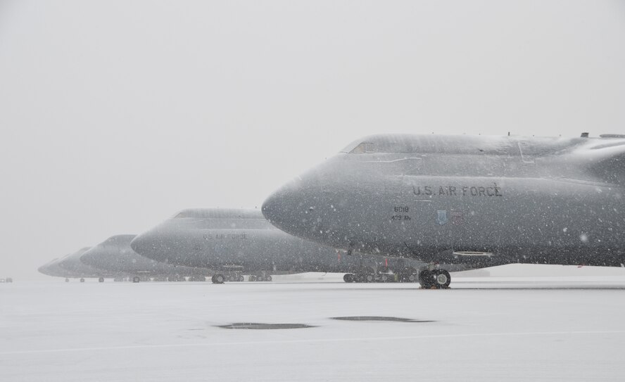 Thick snow begins to fall at Westover, covering the C-5 Galaxies, Feb. 8, 2013. The base is expected to receive anywhere from 13 to 22 inches of snowfall between Friday, Feb. 8, and Sunday, Feb. 10. (U.S. Air Force photo/SrA. Kelly Galloway)