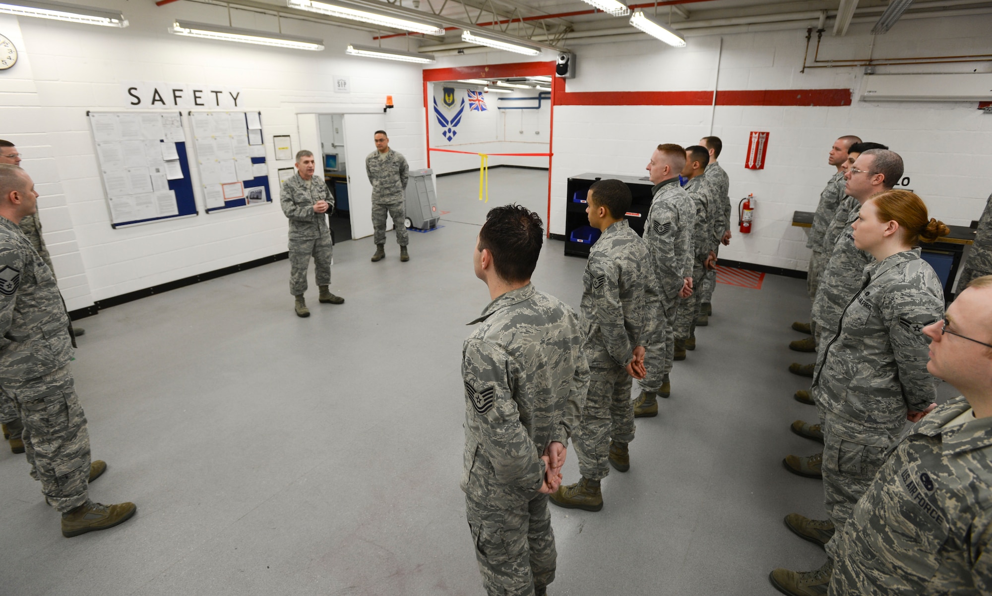 ROYAL AIR FORCE LAKENEHEATH, England - Col. Matthew Cox (center left), 48th Maintenance Group commander, address Airmen of the 48th Component Maintenance Squadron Egress section during a ribbon-cutting ceremony at their new facility Feb. 5, 2013. The section, which maintains egress equipment such as ejection seats, moved to their new facility to increase production and alleviate safety concerns. (U.S. Air Force photo by Staff Sgt. Stephen Linch)