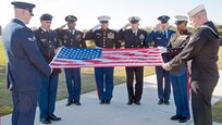 Army Sgt. Maj. Timothy Ricks, Marine Sgt. Maj. Gary Tolar, Navy Master Chief Petty Officer James Perry, and Air Force Command Chief Master Sgt. Jose LugoSantiago salute the United States flag at Joint Base San Antonio-Fort Sam Houston Feb. 1 to showcase the customs and courtesies associated with the playing of “Reveille” and “Retreat.” (U.S. Air Force Photo by Benjamin Faske)