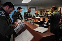 U.S. Air Force F-15E Strike Eagle aircrew members assigned to the 4th Fighter Wing review documents as they prepare for flight during Exercise RAZOR TALON on Seymour Johnson Air Force Base, N.C., Feb. 7, 2013. RAZOR TALON is a monthly Atlantic Coast large-force exercise and joint-unit training opportunity that employs cutting edge operational concepts such as AirSea Battle and Maritime Air Support.  (U.S. Air Force photo/Airman 1st Class Aubrey White/Released)