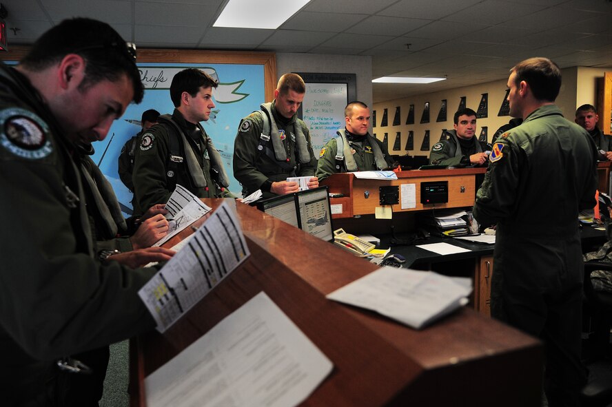 U.S. Air Force F-15E Strike Eagle aircrew members assigned to the 4th Fighter Wing review documents as they prepare for flight during Exercise RAZOR TALON on Seymour Johnson Air Force Base, N.C., Feb. 7, 2013. RAZOR TALON is a monthly Atlantic Coast large-force exercise and joint-unit training opportunity that employs cutting edge operational concepts such as AirSea Battle and Maritime Air Support.  (U.S. Air Force photo/Airman 1st Class Aubrey White/Released)