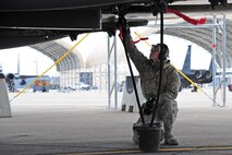 U.S. Air Force Senior Airman Johnny Sears, 4th Aircraft Maintenance Squadron avionics journeyman, collects excess fuel from an F-15E Strike Eagle during Exercise RAZOR TALON on Seymour Johnson Air Force Base, N.C., Feb. 7, 2013. RAZOR TALON is a monthly Atlantic Coast large-force exercise and joint-unit training opportunity that employs cutting edge operational concepts such as AirSea Battle and Maritime Air Support.  (U.S. Air Force photo/Airman 1st Class Aubrey White/Released)