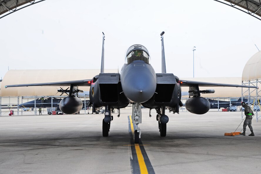 U.S. Air Force Senior Airman Justin Acevedo, 4th Aircraft Maintenance Squadron avionics journeyman, removes chocks from an F-15E Strike Eagle during Exercise RAZOR TALON on Seymour Johnson Air Force Base, N.C., Feb. 7, 2013. RAZOR TALON is a monthly Atlantic Coast large-force exercise and joint-unit training opportunity that employs cutting edge operational concepts such as AirSea Battle and Maritime Air Support. (U.S. Air Force photo/Airman 1st Class Aubrey White/Released)