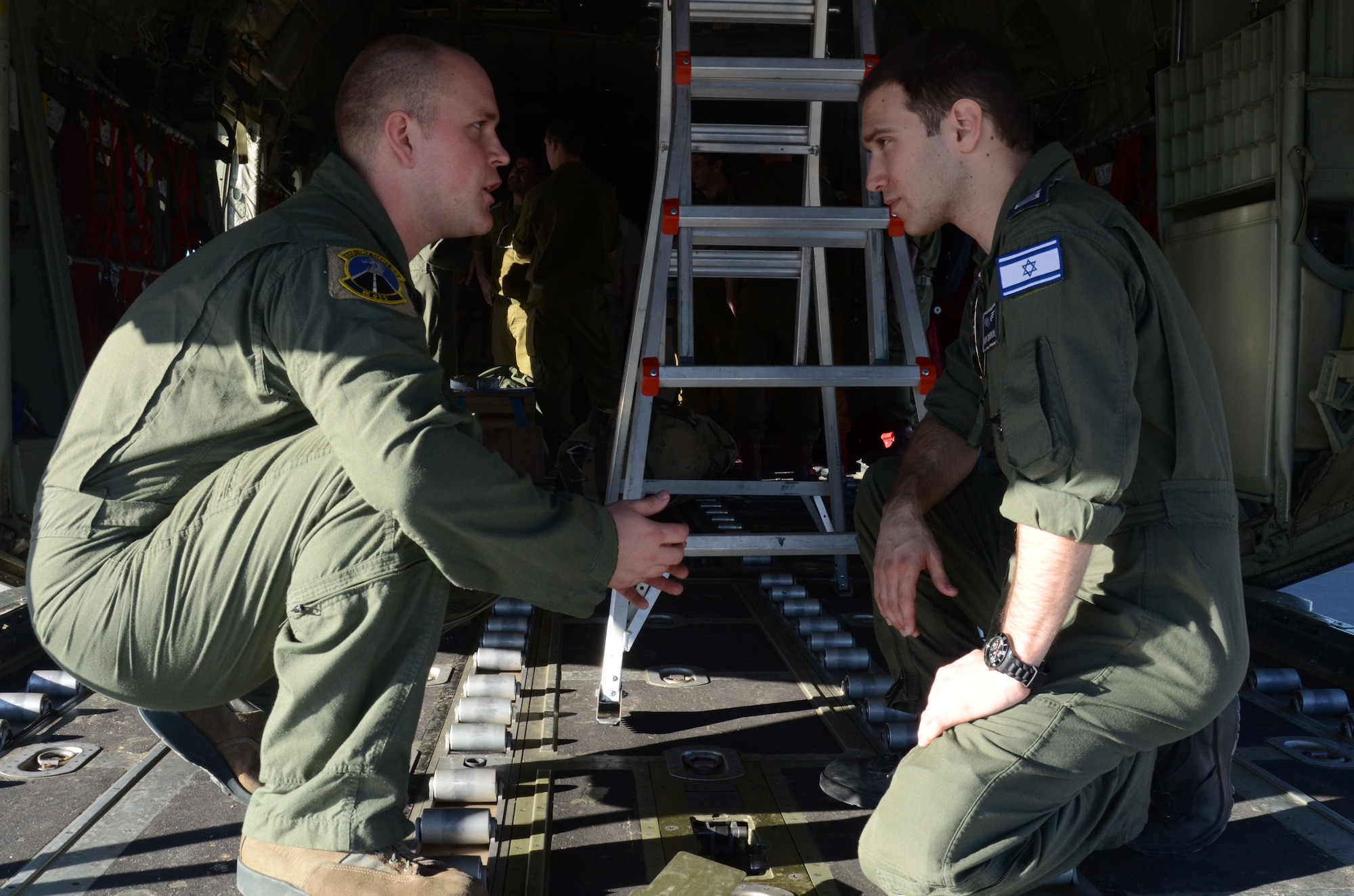 Staff Sgt. Jim Gettis, 86th Operations Support Squadron loadmaster, explains the capabilities of the C-130J Hercules to Segen Rishon Mor Dudkin, 757th Squadron loadmaster, at Nevatim Air Force Base, Israel, Feb. 3, 2013. The 86th Airlift Wing conducted a flying training deployment with the Israeli Air Force in order to strengthen partnerships and maintain readiness for contingency operations. (U.S. Air Force photo / 2nd Lt. Kay M. Nissen)