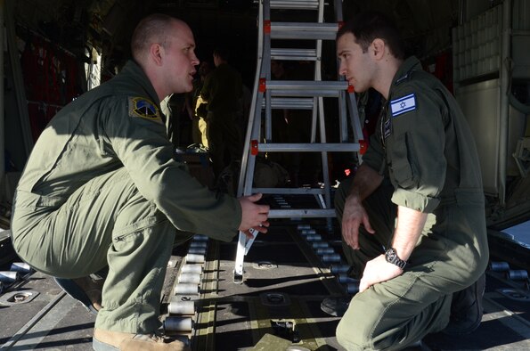 Staff Sgt. Jim Gettis explains the capabilities of the C-130J Hercules to Iraeli air force Segen Rishon Mor Dudkin at Nevatim Air Force Base, Israel, Feb. 3, 2013. The 86th Airlift Wing conducted a flying training deployment with the Israeli Air Force in order to strengthen partnerships and maintain readiness for contingency operations.  Gettis is a , 86th Operations Support Squadron loadmaster. Dudkin is a , 757th Squadron loadmaster. (U.S. Air Force photo/2nd Lt. Kay M. Nissen) 