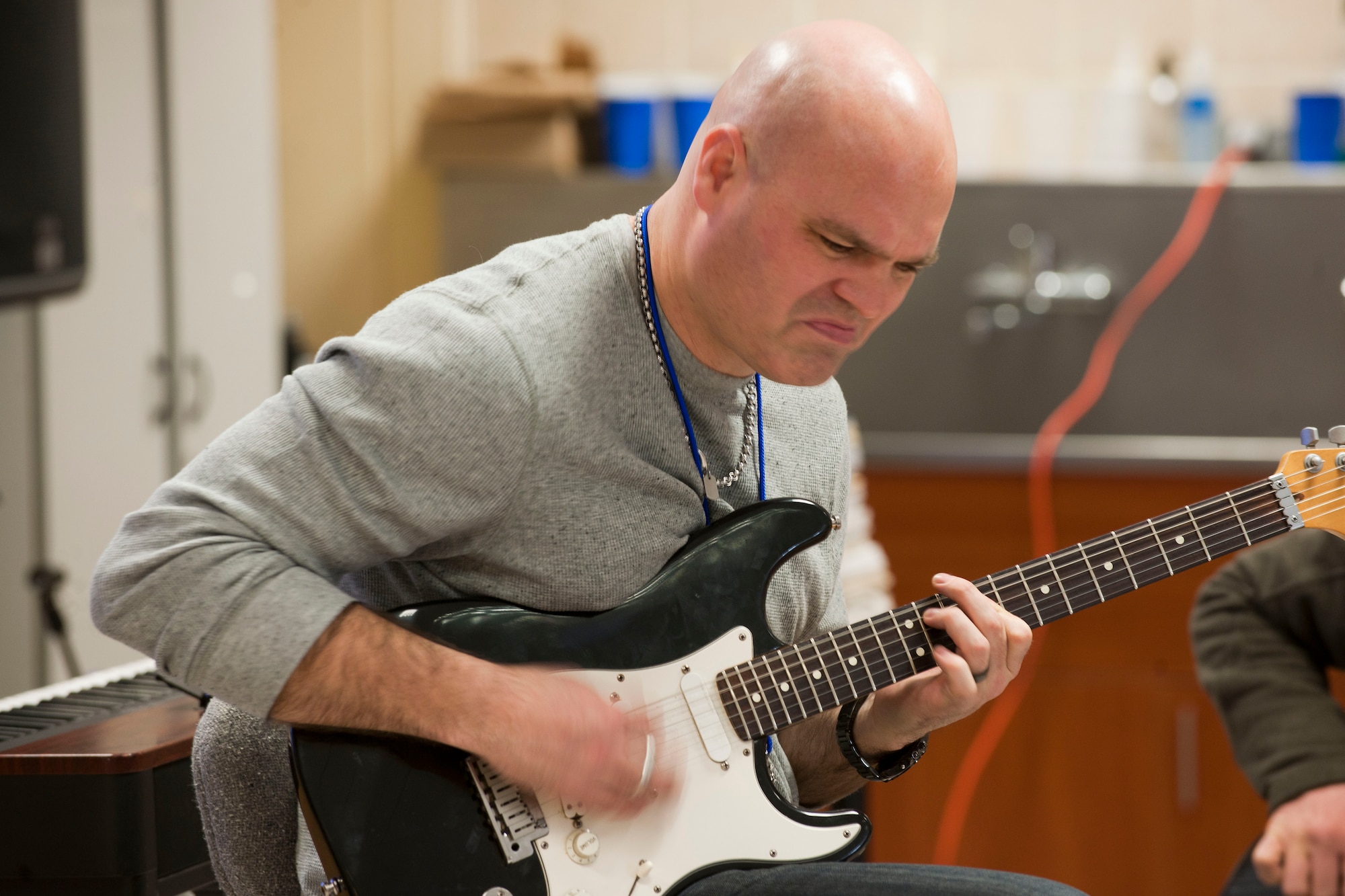 Tech. Sgt. Jason Cale, U.S. Air Forces in Europe band Touch 'N Go guitarist and vocalist, performs a song after giving guitar lessons to Incirlik Unit School students Feb. 7, 2013, at Incirlik Air Base, Turkey. Touch 'N Go performs throughout Europe, Africa and southwest Asia performing for American service members and families while building relationships with host nations or developing countries. (U.S. Air Force photo by Senior Airman Clayton Lenhardt/Released)