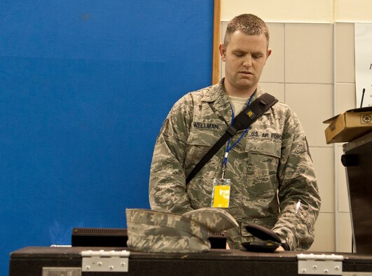 Tech. Sgt. Nick Wellman, U.S. Air Forces in Europe Touch ‘N Go audio technician, listens to the music as he makes the proper adjustments during a concert at Incirlik Unit School Feb. 4, 2013, at Incirlik Air Base, Turkey. Touch 'N Go performed and gave music lessons at IUS, and will perform at an annual awards ceremony to finish their visit to Incirlik. (U.S. Air Force photo by Senior Airman Daniel Phelps/Released)