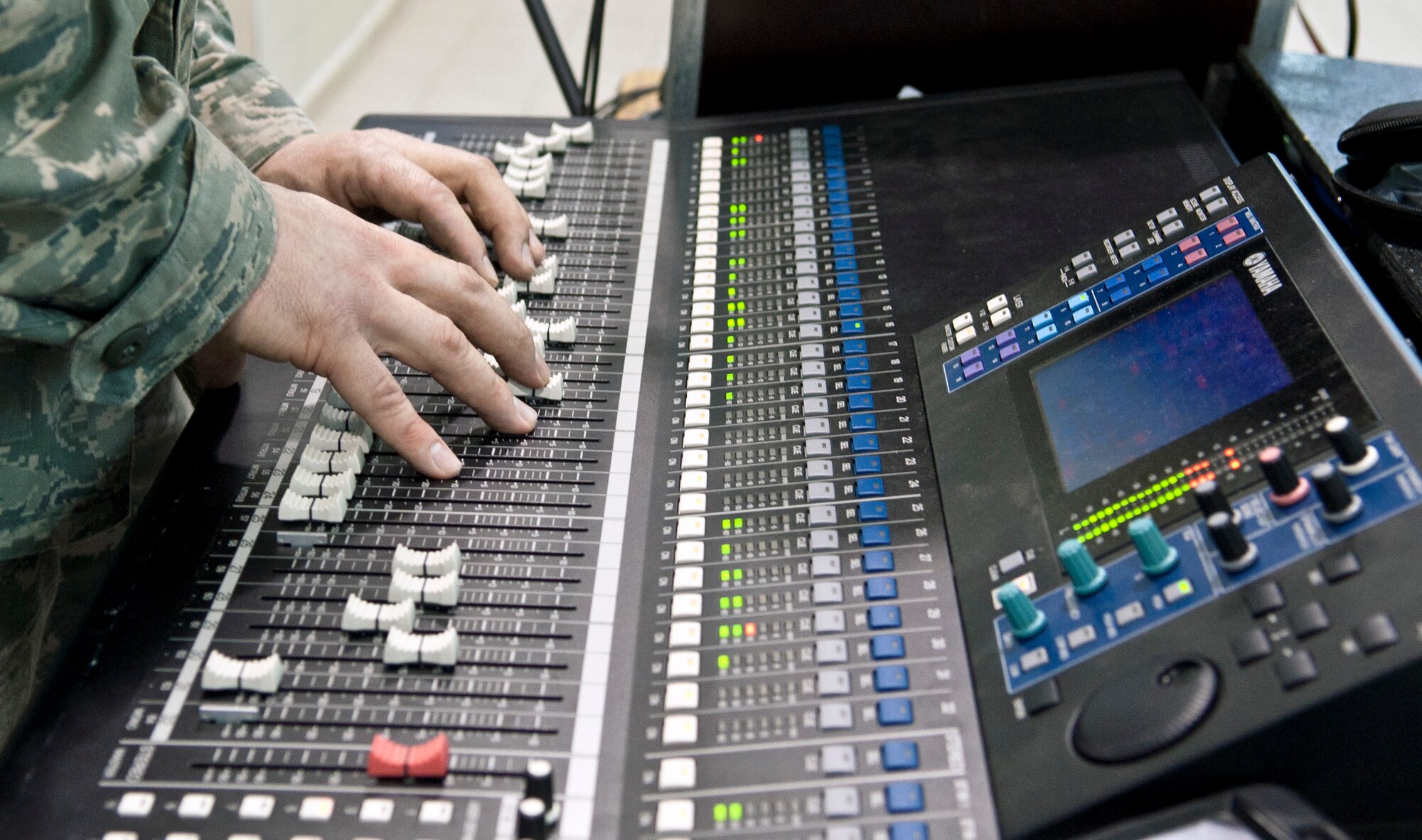 Tech. Sgt. Nick Wellman, U.S. Air Forces in Europe Touch ‘N Go audio technician, fine tunes the soundboard during a concert at Incirlik Unit School Feb. 4, 2013, at Incirlik Air Base, Turkey. Touch ‘N Go is the pop music ensemble of the USAFE band. (U.S. Air Force photo by Senior Airman Daniel Phelps/Released)
