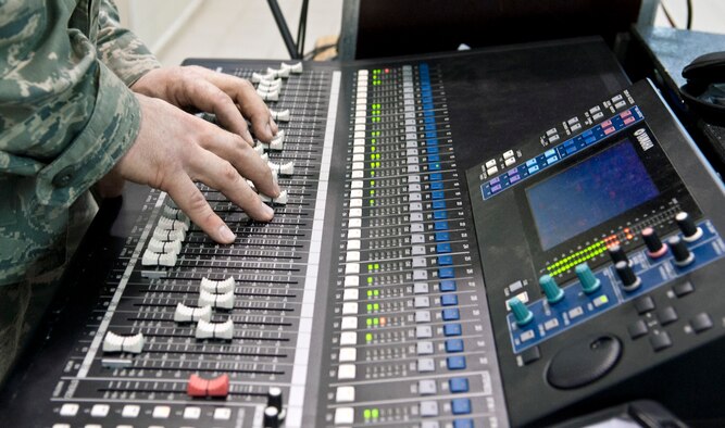 Tech. Sgt. Nick Wellman, U.S. Air Forces in Europe Touch ‘N Go audio technician, fine tunes the soundboard during a concert at Incirlik Unit School Feb. 4, 2013, at Incirlik Air Base, Turkey. Touch ‘N Go is the pop music ensemble of the USAFE band. (U.S. Air Force photo by Senior Airman Daniel Phelps/Released)