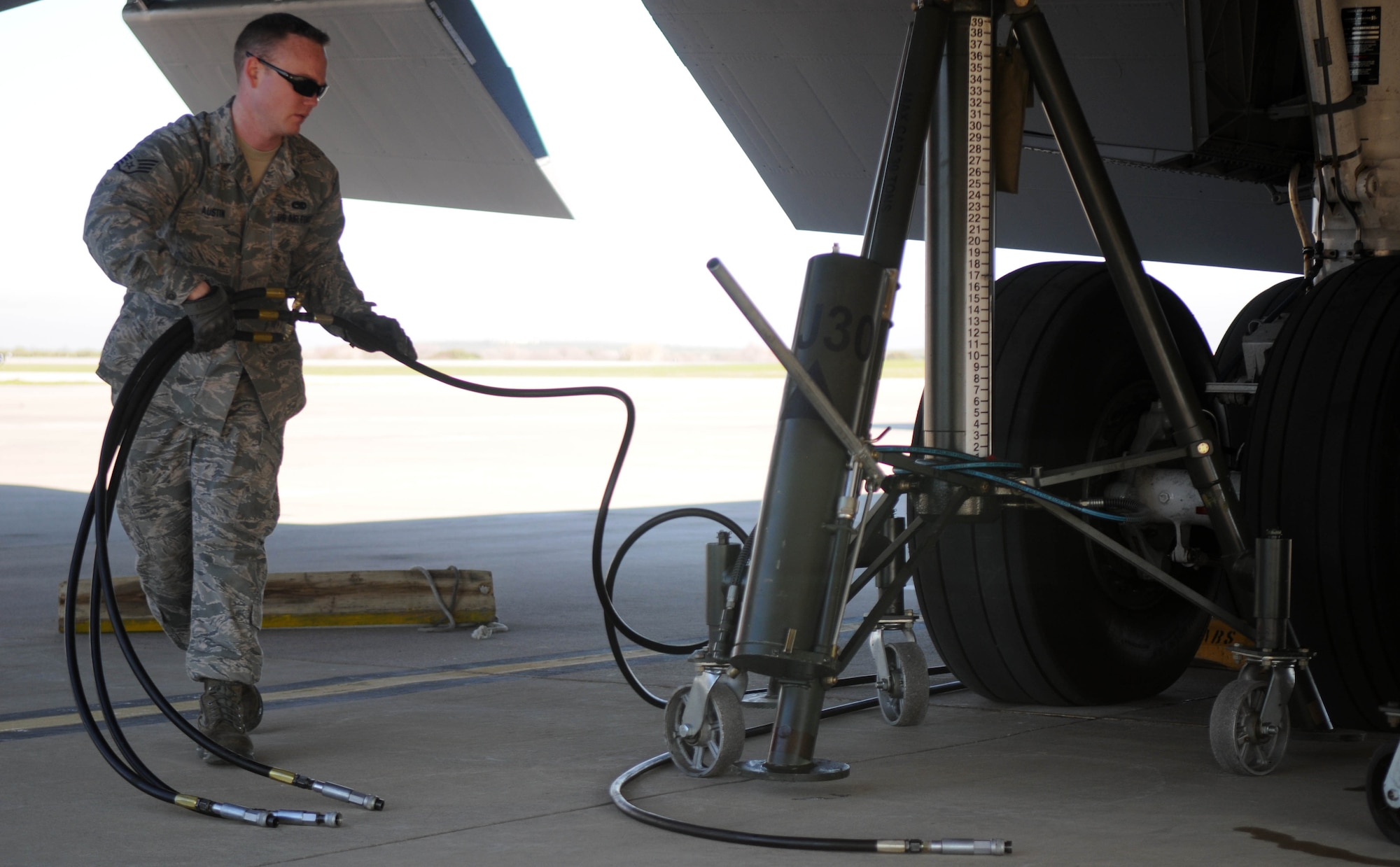 Staff Sgt. Richard Austin, 100th Aircraft Maintenance Squadron, prepares to connect hydraulic lines to a tripod jack under a KC-135 Stratotanker Feb. 5, 2013, at an air base in southwest Europe. Jacks allow maintainers to conduct tests involving raising and lowering the aircraft’s landing gear. Airmen from RAF RAF Mildenhall, England, deployed to southwest Europe in January to support French operations in Mali. Austin is from Norfolk, Va. (U.S. Air Force photo by Staff Sgt. Austin M. May)