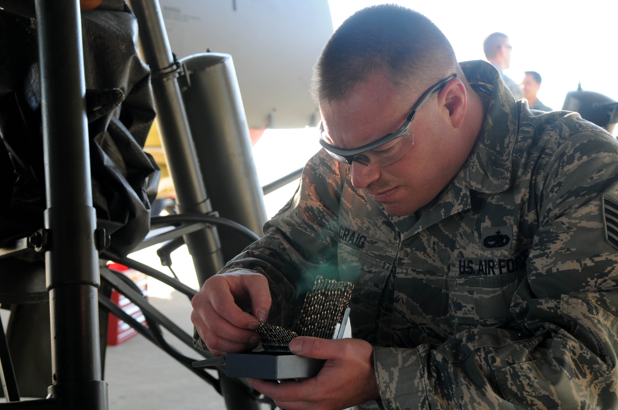 Tech. Sgt. Jason Craig, 100th Aircraft Maintenance Squadron, selects a drill bit before working on a KC-135 Stratotanker in preparation for lifting the aircraft on hydraulic jacks Feb. 5, 2013. Jacks allow maintainers to conduct tests involving raising and lowering the aircraft’s landing gear. Airmen from RAF Mildenhall, England, deployed to southwest Europe in January to support French operations in Mali. Craig is from Santa Paula, Calif. (U.S. Air Force photo by Staff Sgt. Austin M. May)