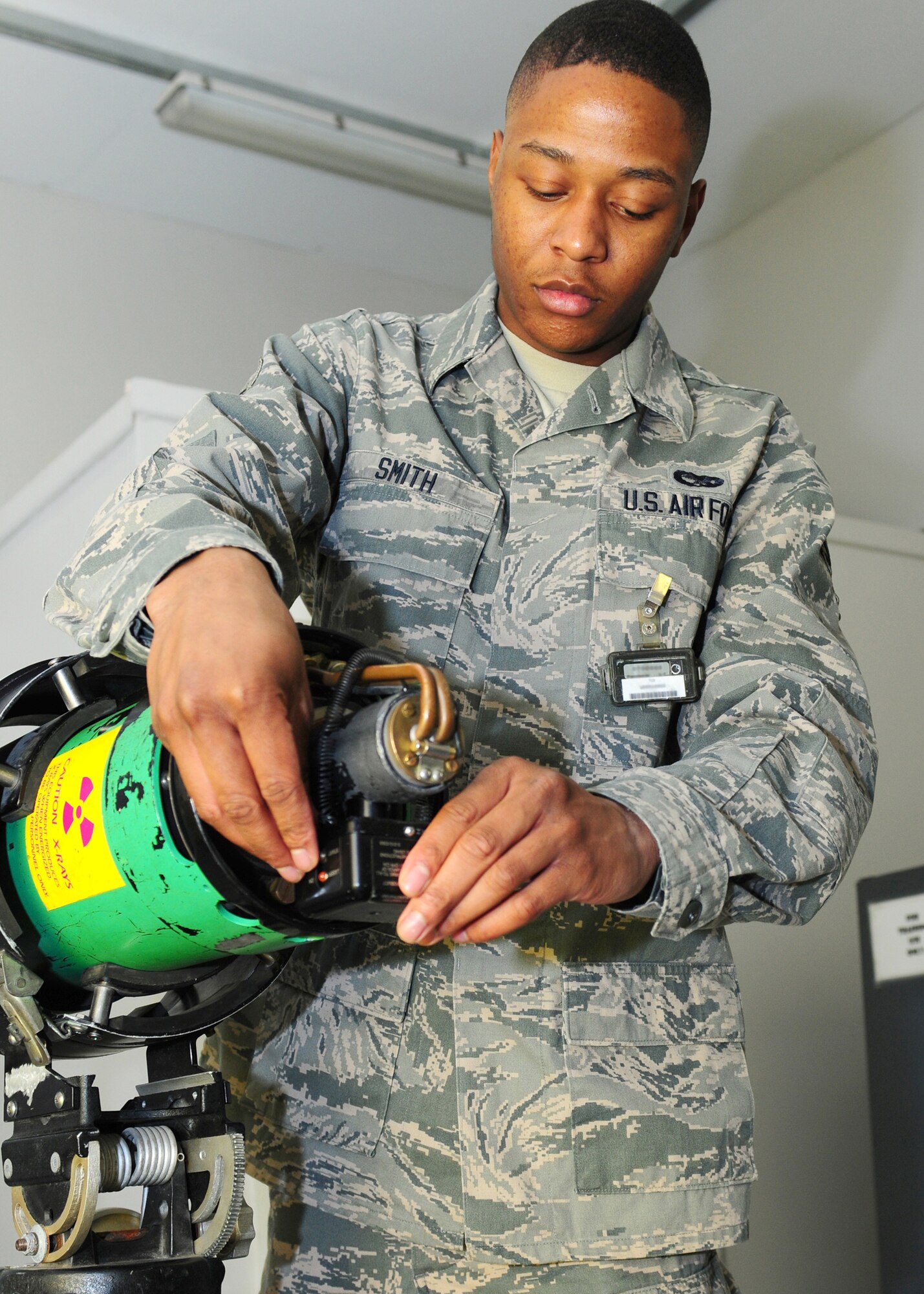 ROYAL AIR FORCE LAKENHEATH, England -- Airman 1st Class Devonte Smith, 48th Equipment Maintenance Squadron nondestructive inspection apprentice, adjusts a laser pointer on the tube head of a piece of equipment to ensure that the x-ray beam focal point is accurate Feb 6, 2013. Smith was nominated for a Liberty Spotlight because he displays the core value of "Service Before Self." (U.S. Air Force photo by Airman 1st Class Dana J. Butler)