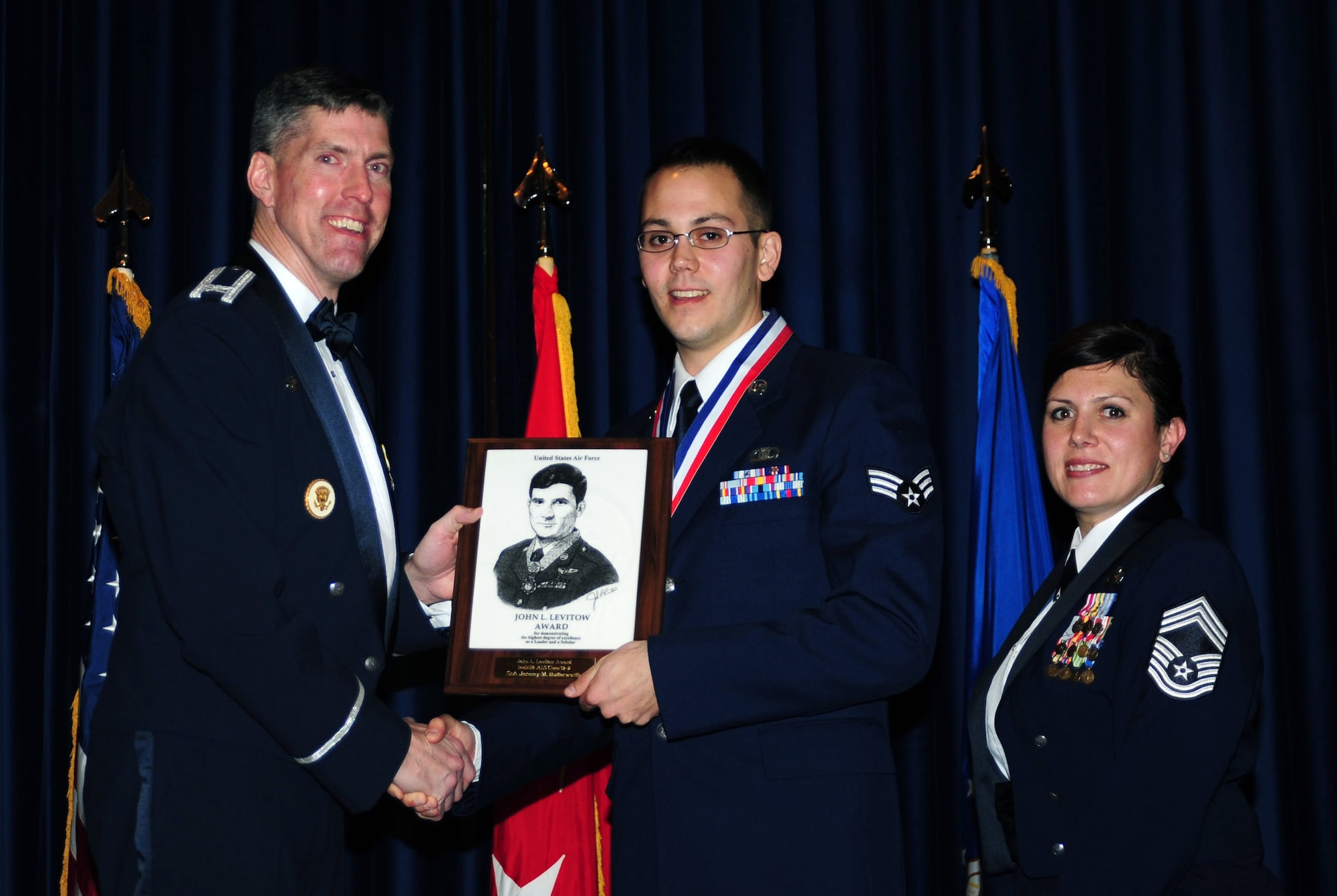 Senior Airman Jeremy Butterworth, 39th Operations Squadron, receives the John L. Levitow Award from Col. Chris Craige, 39th Air Base Wing commander, during the Class 13-2 graduation Feb. 7, 2013, at Incirlik Air Base, Turkey. The Levitow Award is the highest achievement for enlisted Airmen enrolled in U.S. Air Force professional military education. There are four levels of PME: ALS, NCO Academy, Air Force Senior NCO Academy and Chief Master Sergeant Leadership Course. (U.S. Air Force photo by Senior Airman Anthony Sanchelli/Released)