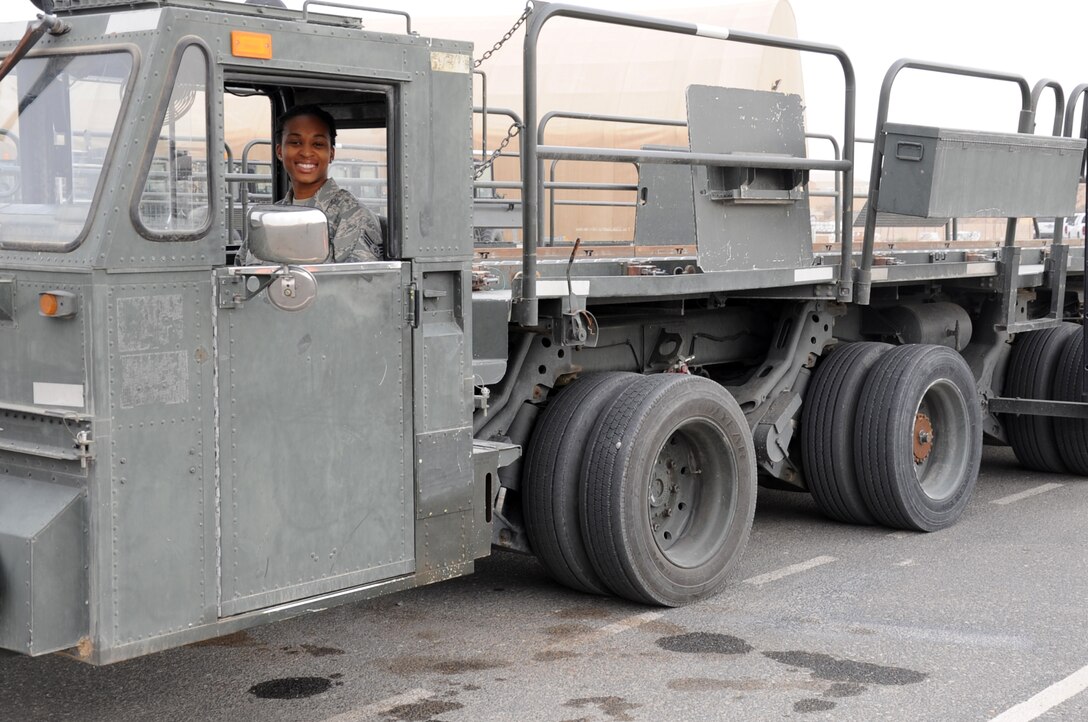 Senior Airman Denice Luke, 386th Expeditionary Logistics Readiness Squadron poses inside a 60 K-Loader at a base in Southwest Asia Feb. 8. Luke is serving on her first deployment from Robins Air Force Base Ga. to the Air Force Central Command Area of Responsibility. (U.S. Air Force photo by Senior Master Sgt. George Thompson)