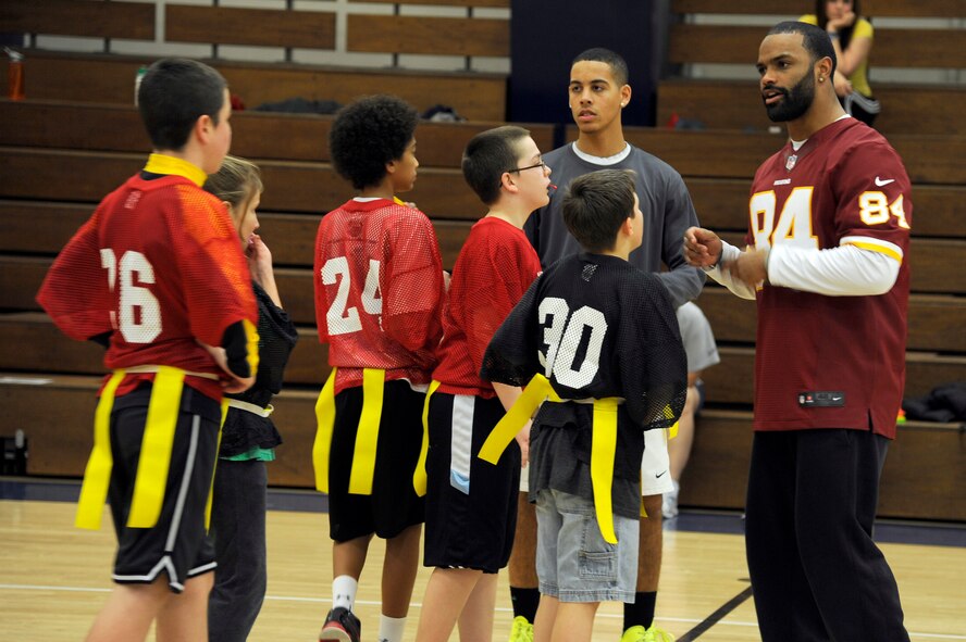 Niles Paul, Washington Redskins tight end, talks to players at the Misawa Youth Football Clinic on Misawa Air Base, Japan, Feb. 4, 2013. At the clinic, participants had the opportunity to receive advice and learn skills from two National Football League players. (U.S. Air Force photo by Tech. Sgt. Marie Brown) 