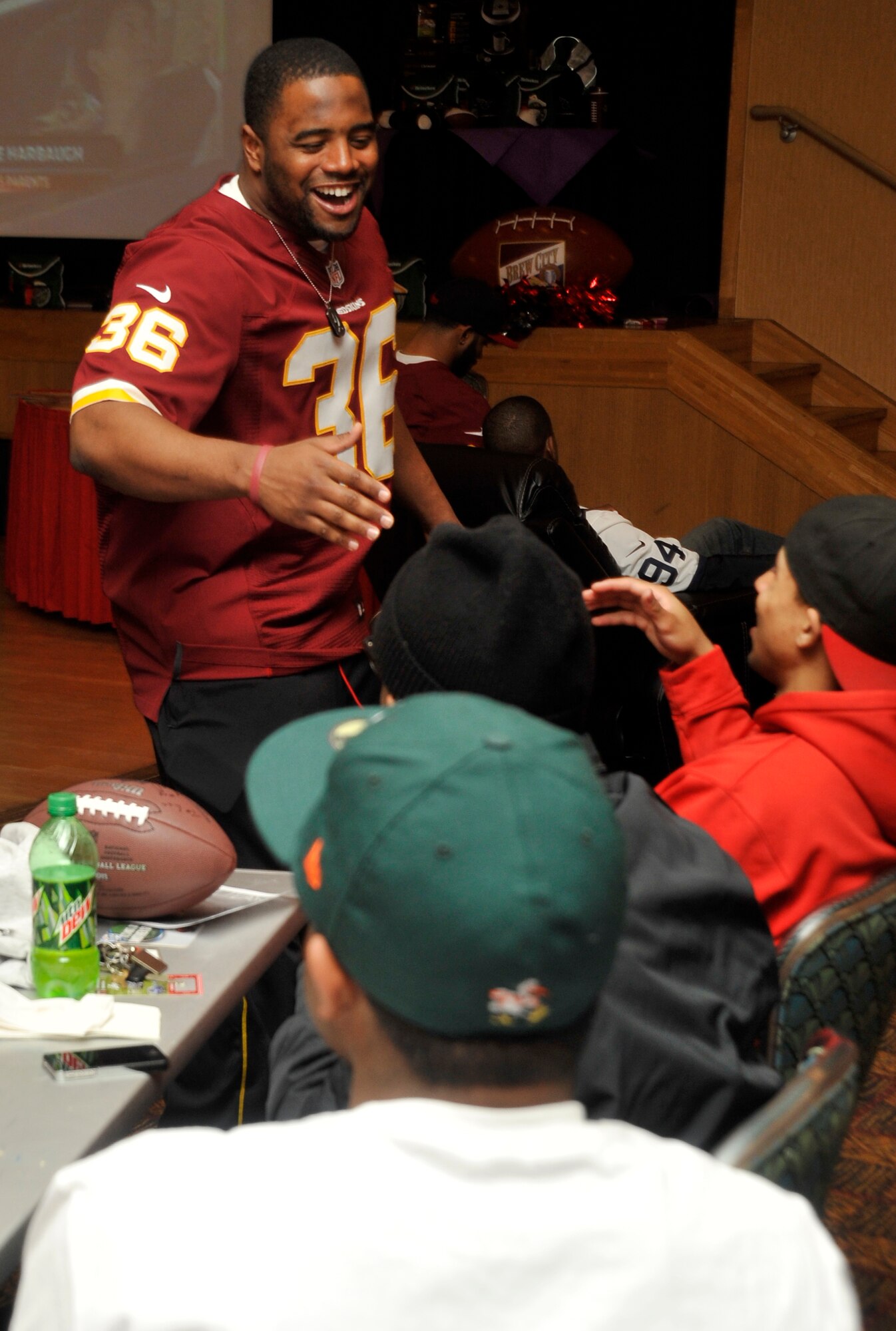 Darrel Young, Washington Redskins fullback, greets members of the base community before the start of the Super Bowl XLVII at the Misawa Club Complex on Misawa Air Base, Japan, Feb. 5, 2013. Coming to Misawa was a way for the NFL stars to show their appreciation to those who serve at Misawa. (U.S. Air Force photo by Airman 1st Class Zachary Kee)