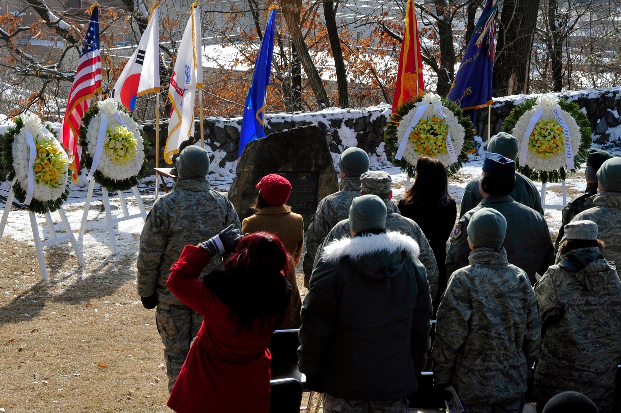 More than 100 Osan community members stand for Taps after the wreath laying at the 62nd Anniversary of the Battle of Bayonet Hill Commemoration Ceremony Feb. 7, 2013, at the Hill 180 Site, Osan Air Base, Republic of Korea.  The battle marked the last time bayonets were used in combat. (U.S. Air Force photo/Airman 1st Class Alexis Siekert)