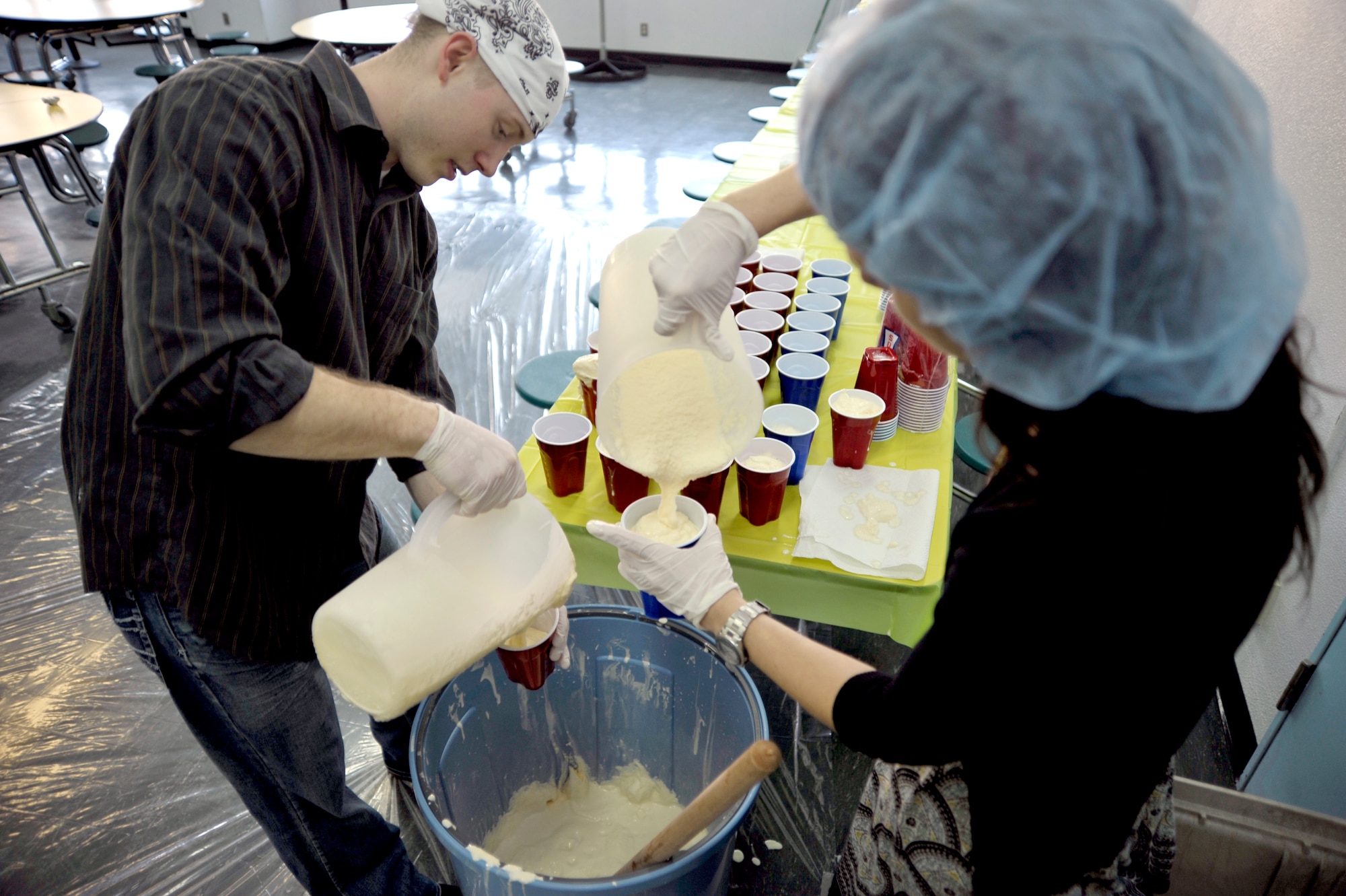 Club Beyond volunteers pour milkshakes that were made in a garbage can for students at Robert D. Edgren High School before the first Club Beyond meeting to kick off the year at Misawa Air Base, Japan, Feb. 1, 2013. Luckily for the students, the Club Beyond volunteers used a clean garbage can that had never been used to hold trash. (U.S. Air Force photo by Staff Sgt. Nathan Lipscomb)