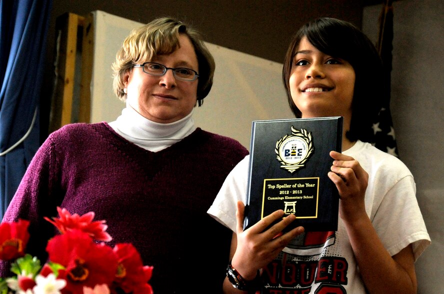 A sixth grade student shows his award to the crowd after winning the final round of the Cummings Elementary School Spelling Bee competition at Misawa Air Base, Japan, Feb. 4, 2013. Three students from grades 3, 4, 5 and 6 made it to the final round of the competition. (U.S. Air Force photo by Airman 1st Class Kenna Jackson)