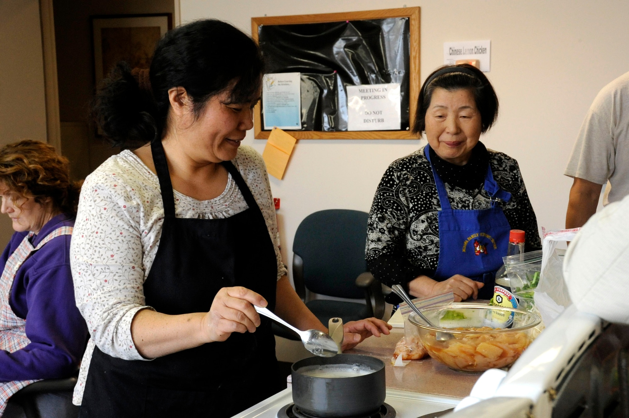 Julene Martindale, left, shows Tomo Oyamada, how to make lemon chicken sauce during a Chinese cooking class in the Airman and Family Readiness Center kitchen at Misawa Air Base, Japan, Feb. 4, 2013. The class was led by Martindale, who knows how to make Chinese Lemon Chicken and wanted to share that knowledge with willing students. (U.S. Air Force photo by Airman 1st Class Kenna Jackson)