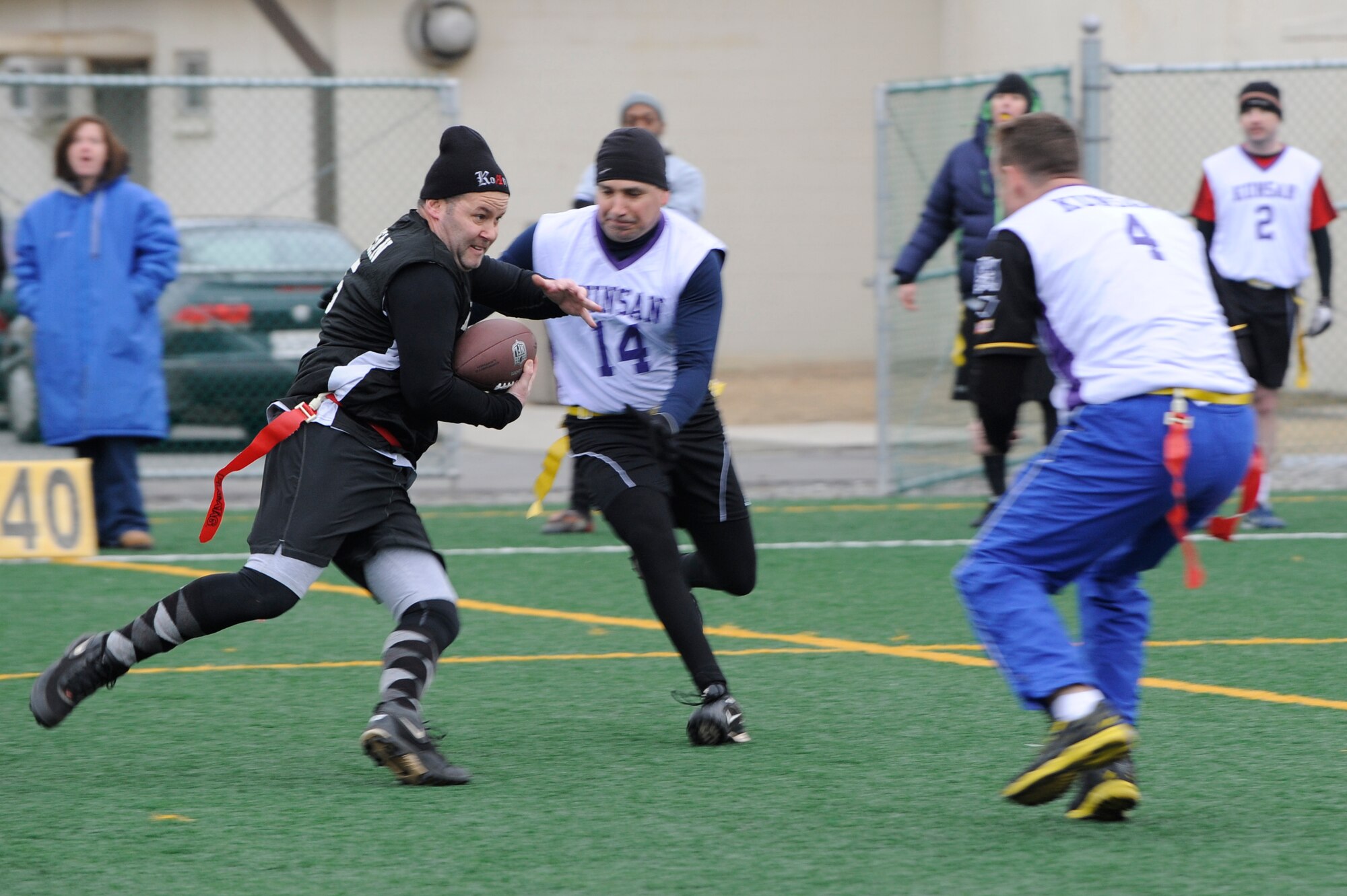 Chief Master Sgt. Robert Wydler, left, 8th Maintenance Group, runs down the field during the Chiefs and Eagles flag football game at Kunsan Air Base, Republic of Korea, Feb. 3, 2013. The Eagles beat the Chiefs 24-0. (U.S. Air Force photo by Senior Airman Marcus Morris/Released)