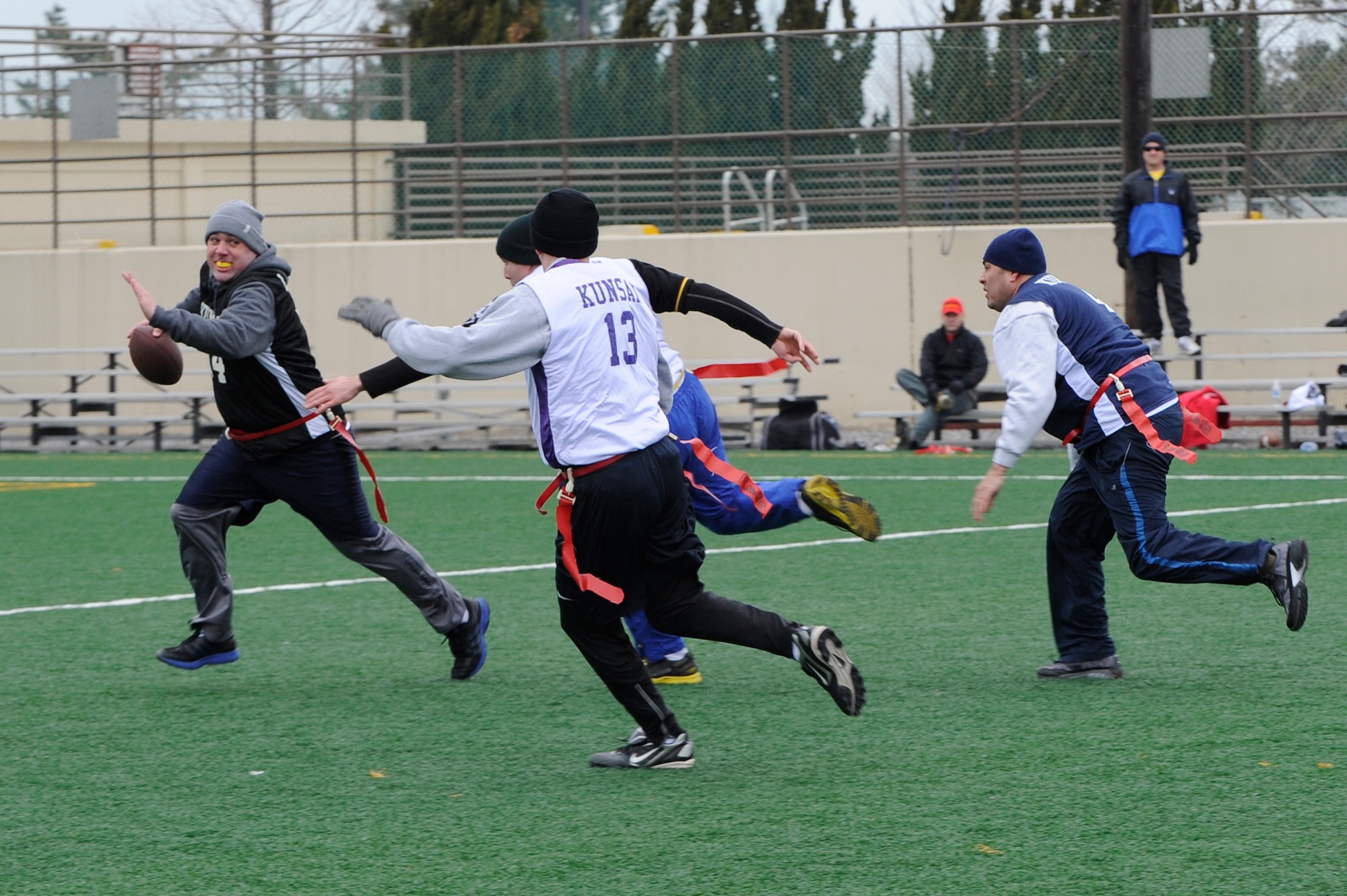 Chief Master Sgt. Daniel Stein, 8th Operations Group, runs from the Eagles’ defense during the Chiefs and Eagles flag football game at Kunsan Air Base, Republic of Korea, Feb. 3, 2013. The Eagles beat the Chiefs 24-0. (U.S. Air Force photo by Senior Airman Marcus Morris/Released)