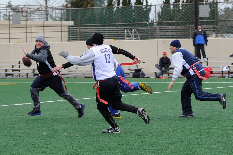 Chief Master Sgt. Daniel Stein, 8th Operations Group, runs from the Eagles’ defense during the Chiefs and Eagles flag football game at Kunsan Air Base, Republic of Korea, Feb. 3, 2013. The Eagles beat the Chiefs 24-0. (U.S. Air Force photo by Senior Airman Marcus Morris/Released)
