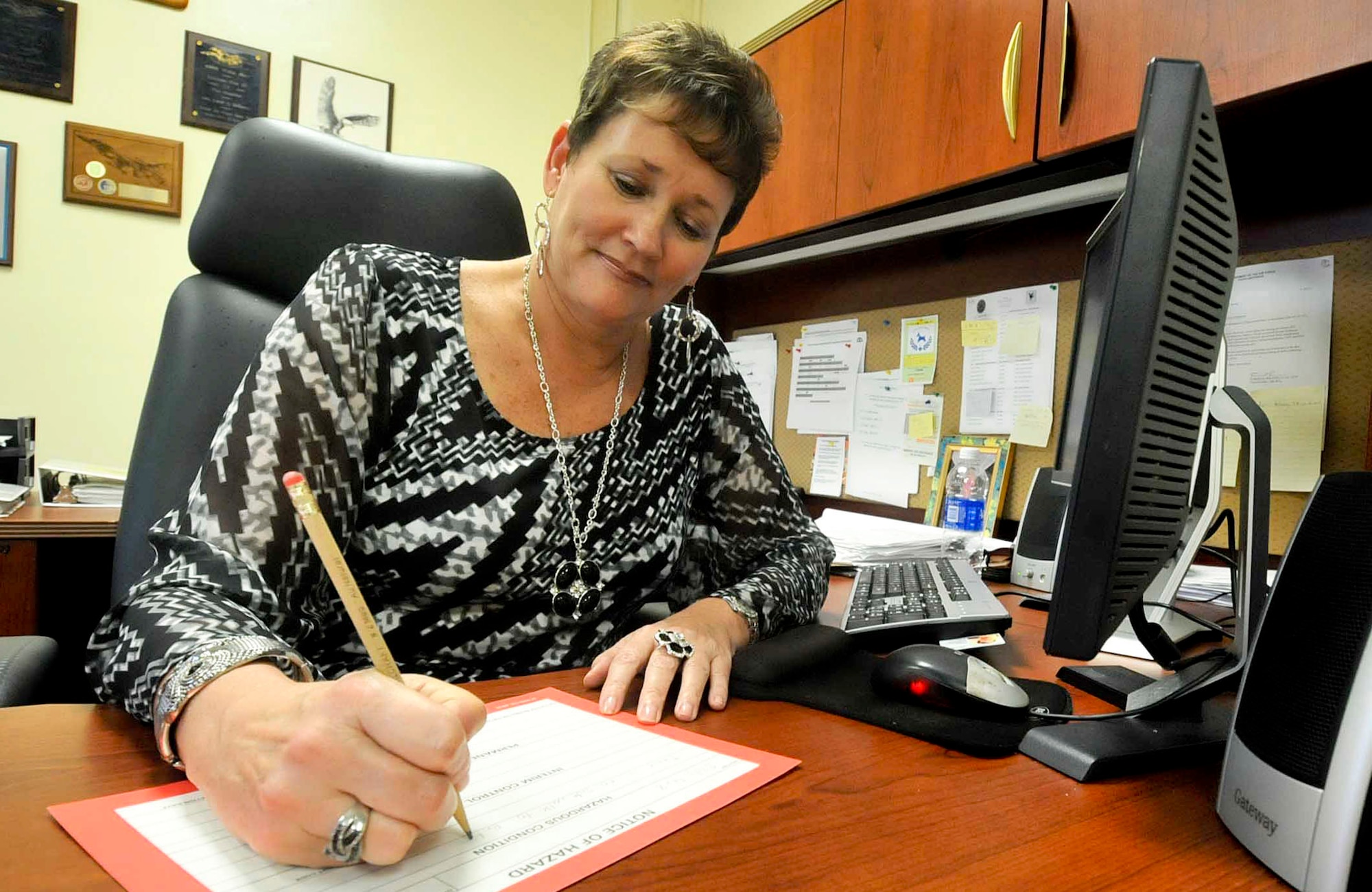 Lorie Bellamy, 18th Wing ground safety manager, fills out a hazard report on Kadena Air Base, Japan, Feb. 7, 2013. The ground safety team has six members who provide a safety program to more than 25,000 people and protect $6 billion worth of resources. (U.S. Air Force photo/Staff Sgt. Darnell T. Cannady)