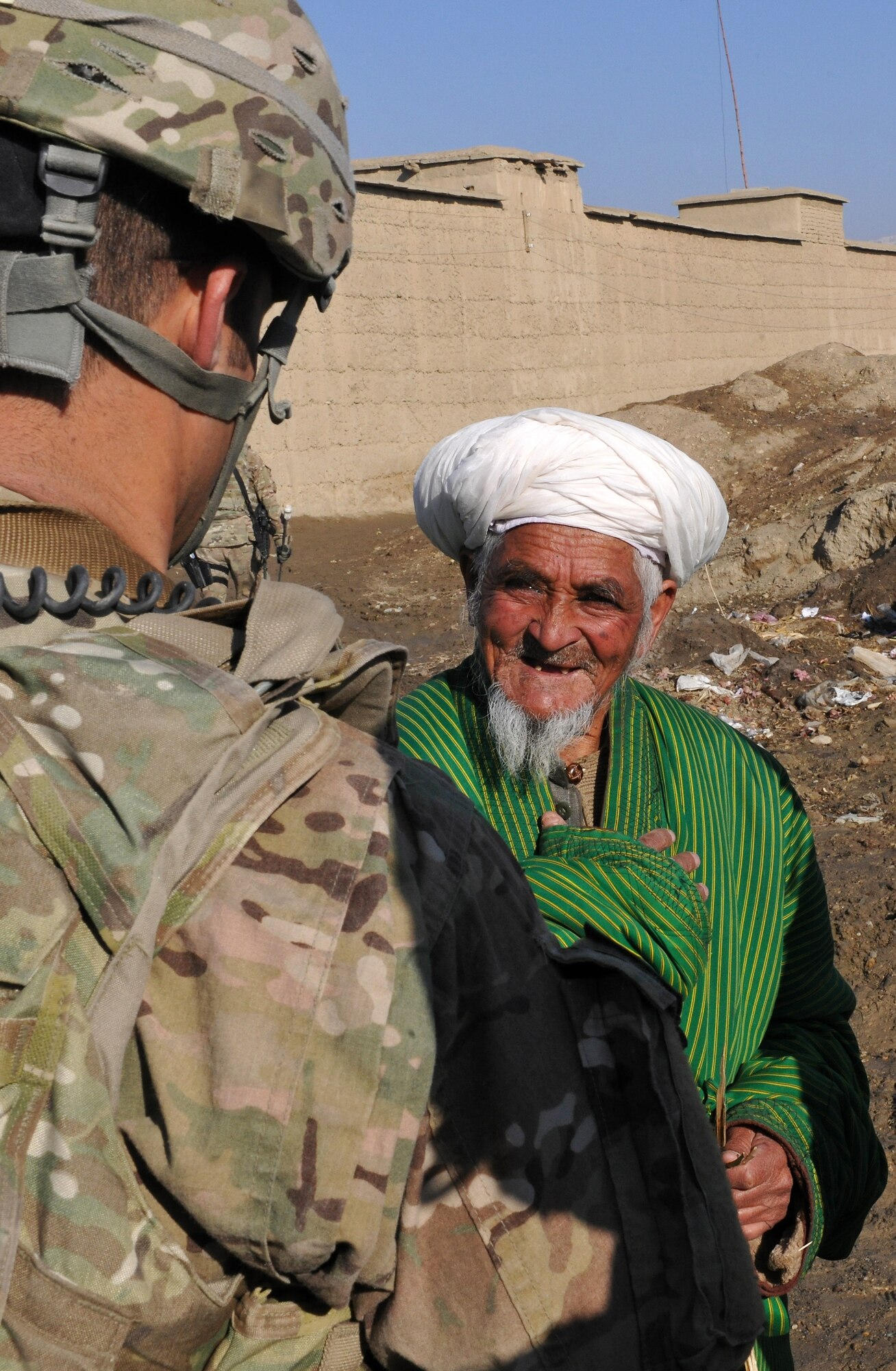 Airmen talk to local leaders and water well caretakers at a village near Bagram Airfield, Afghanistan, Jan. 26, 2013.  The Airmen teamed up with local Afghan leaders to fix the broken water wells and bring the fresh groundwater back to the village.  (U.S. Air Force photo/Senior Airman Chris Willis)