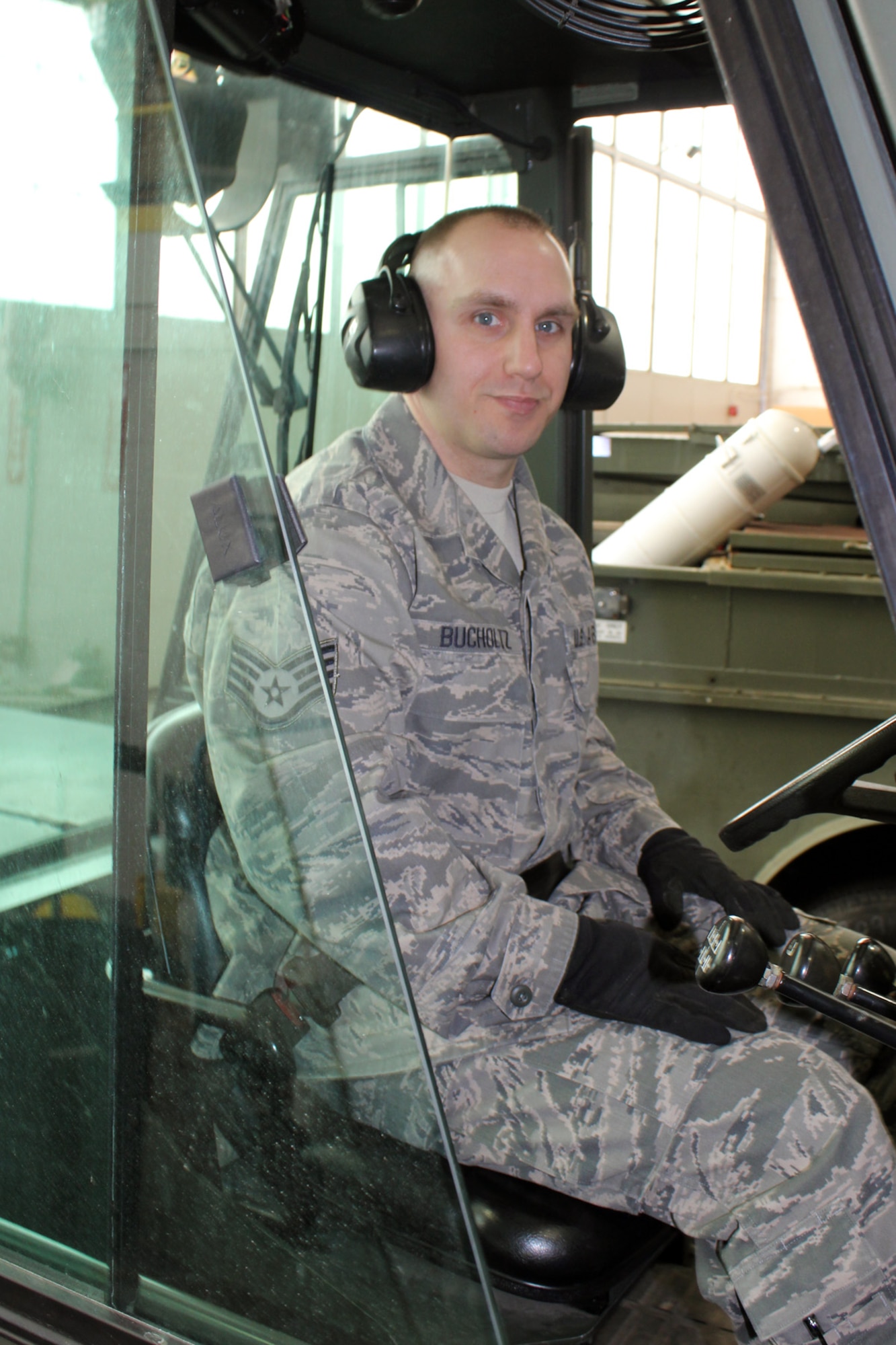 Staff Sgt. Jason Bucholtz, 127th Logistics Readiness Squadron, wears a seat belt and hearing protection as he prepares to use a 10K forklift to move a pallet of cargo at Selfridge Air National Guard Base, Mich., Feb. 9, 2013. As a member of the Aerial Port at the base, Bucholtz is charged with the safe and efficient movement of cargo and personnel on military aircraft. (Air National Guard photo by TSgt. Dan Heaton)