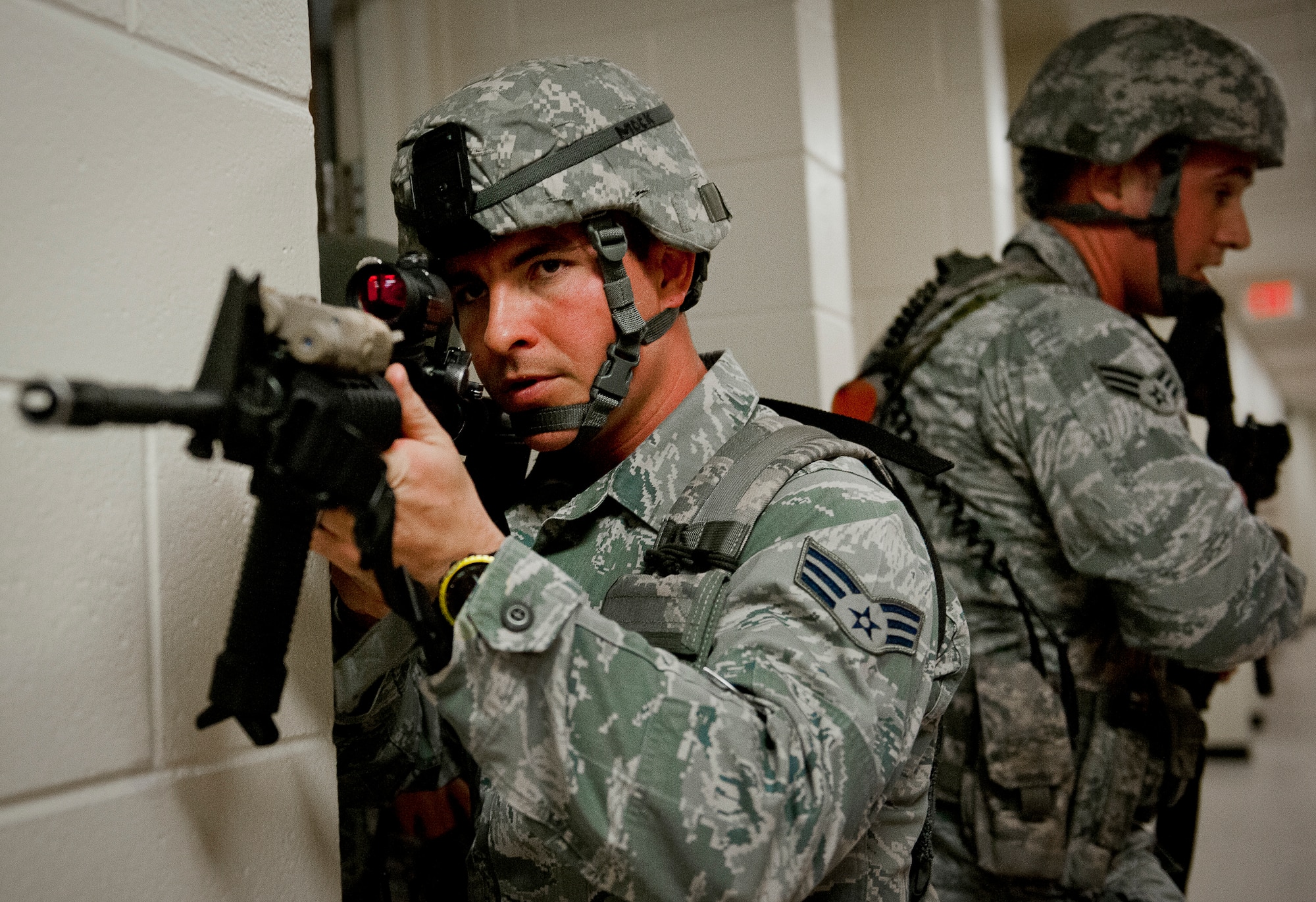 Senior Airman Bradley Mock, of the 96th Security Force Squadron, watches the hallways as his team prepares to move during an active shooter exercise at Eglin Air Force Base, Feb. 6.  The Airmen entered the building to apprehend the suspect, assess the wounded and report back information to the emergency responders.  (U.S. Air Force photo/Samuel King Jr.)