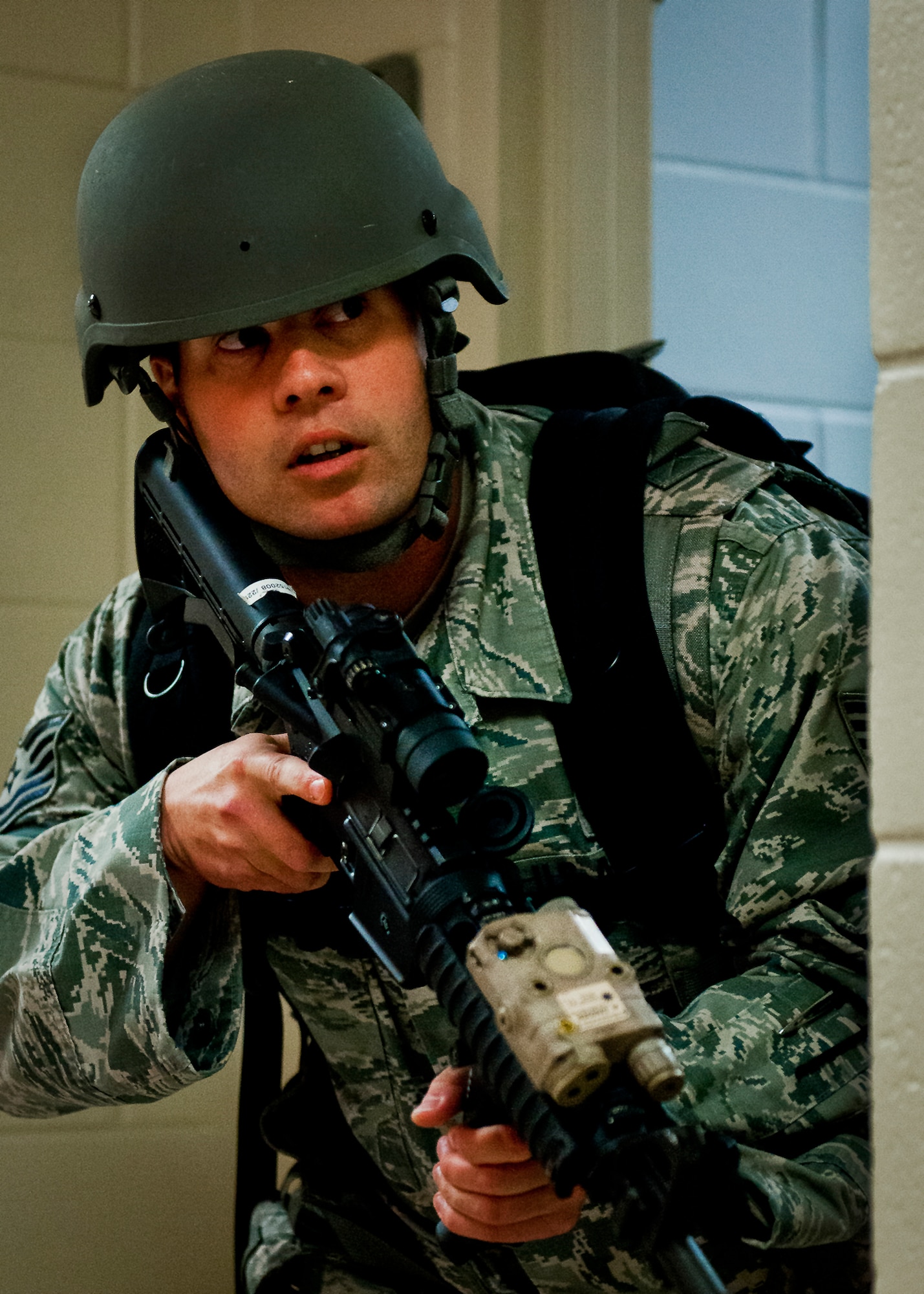 Tech Sgt. Daniel Hurlbert, of the 96th Security Forces Squadron, watches the hall ways while his team search a room during an active shooter exercise at Eglin Air Force Base, Feb. 6.  The Airmen entered the building to apprehend the suspect, assess the wounded and report back information to the emergency responders.  (U.S. Air Force photo/Samuel King Jr.)
