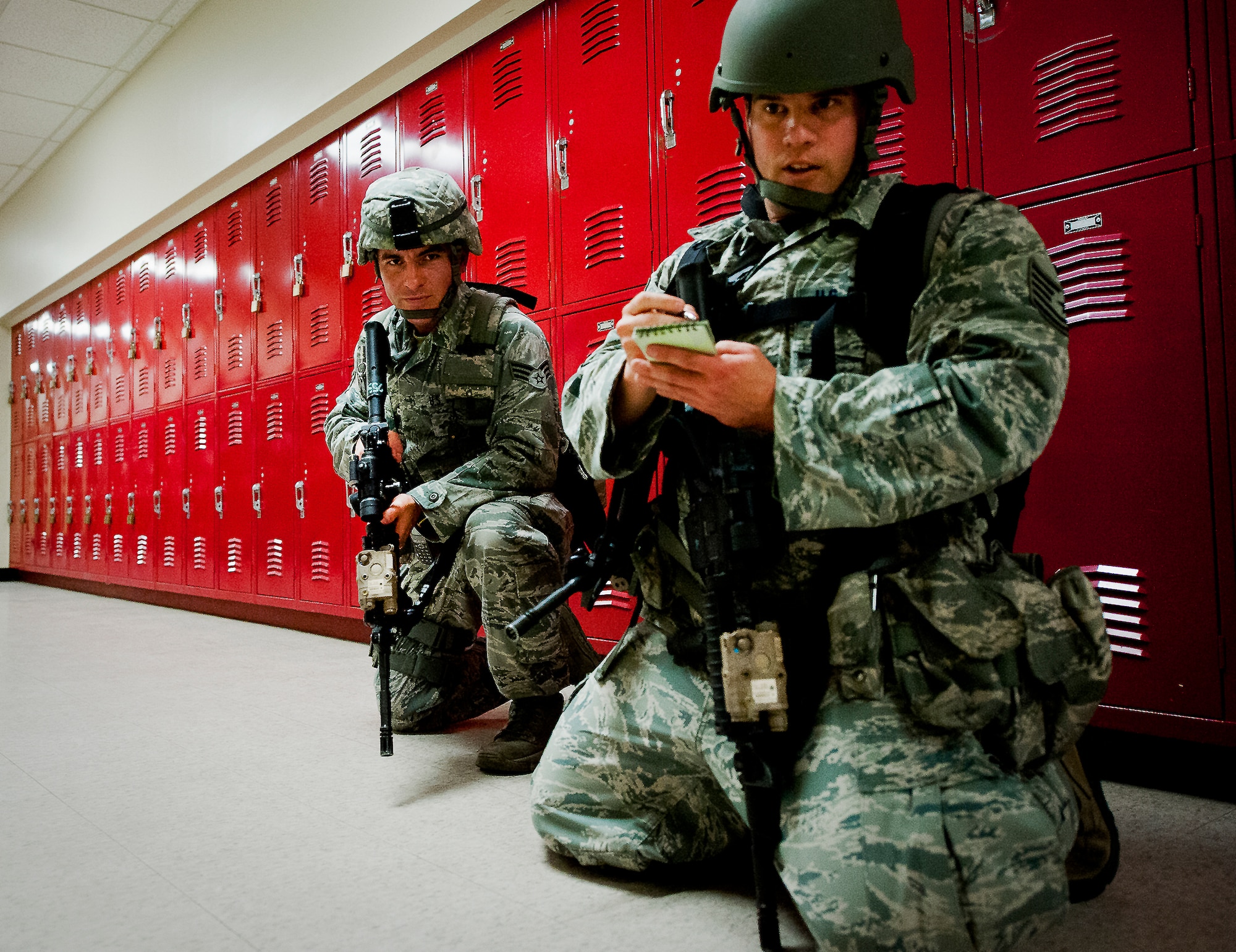 Tech Sgt. Daniel Hurlbert, of the 96th Security Forces Squadron, writes down information about a simulated bomb left by the suspect during an active shooter exercise at Eglin Air Force Base, Feb. 6.  Security Forces Airmen entered the building to apprehend the suspect, assess the wounded and report back information to the emergency responders.  (U.S. Air Force photo/Samuel King Jr.)
