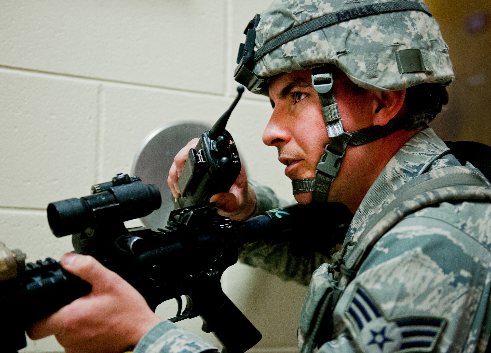 Senior Airman Bradley Mock, of the 96th Security Force Squadron, communicates what’s happening in the building to Airmen on the outside during an active shooter exercise at Eglin Air Force Base, Feb. 6.  Security Forces Airmen entered the building to apprehend the suspect, assess the wounded and report back information to the emergency responders.  (U.S. Air Force photo/Samuel King Jr.)