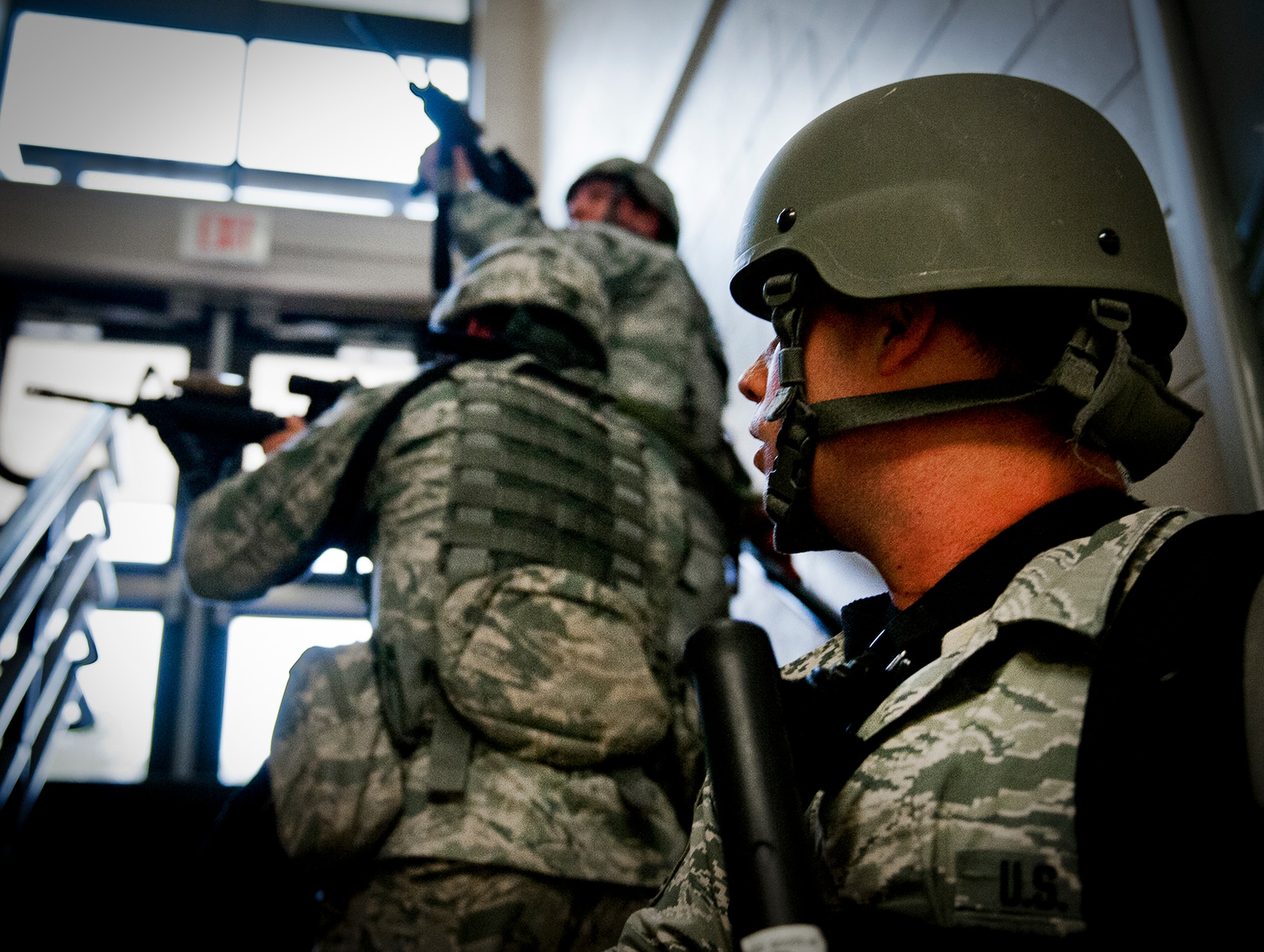 Tech Sgt. Daniel Hurlbert, of the 96th Security Forces Squadron, waits for his team to advance up the stairway during an active shooter exercise at Eglin Air Force Base, Feb. 6.  Security Forces Airmen entered the building to apprehend the suspect, assess the wounded and report back information to the emergency responders.  (U.S. Air Force photo/Samuel King Jr.)