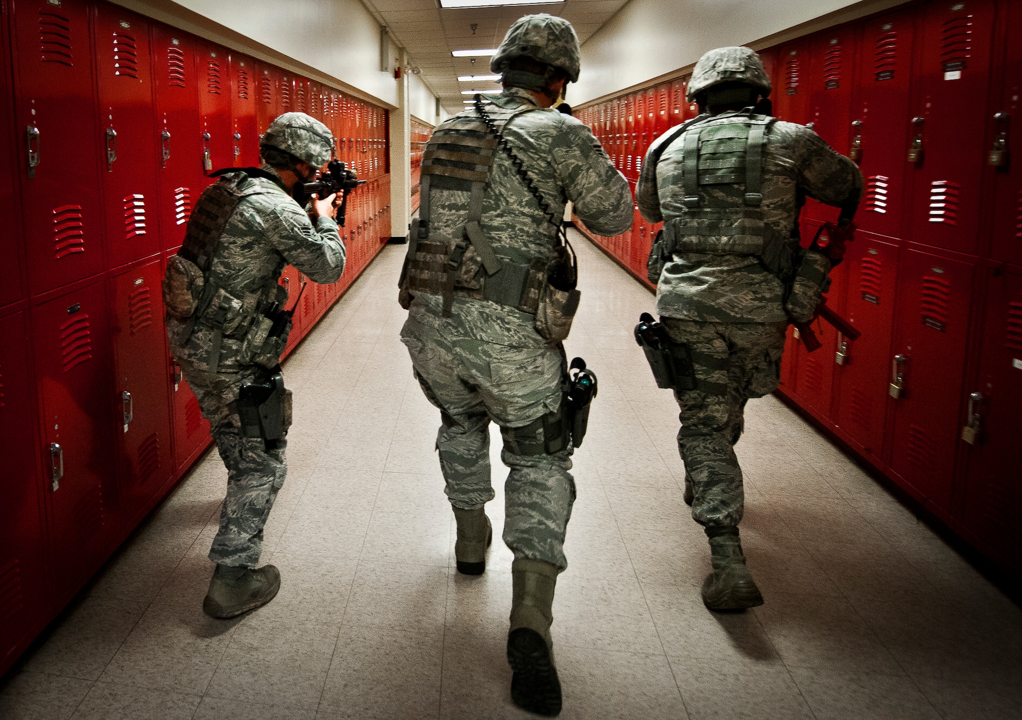Senior Airmen Bradley Mock, Michael Fisk and Dominique Adams, of the 96th Security Forces Squadron, search a hallway of Building 845 during an active shooter exercise at Eglin Air Force Base, Feb. 6.  Security Forces Airmen entered the building to apprehend the suspect, assess the wounded and report back information to the emergency responders.  (U.S. Air Force photo/Samuel King Jr.)