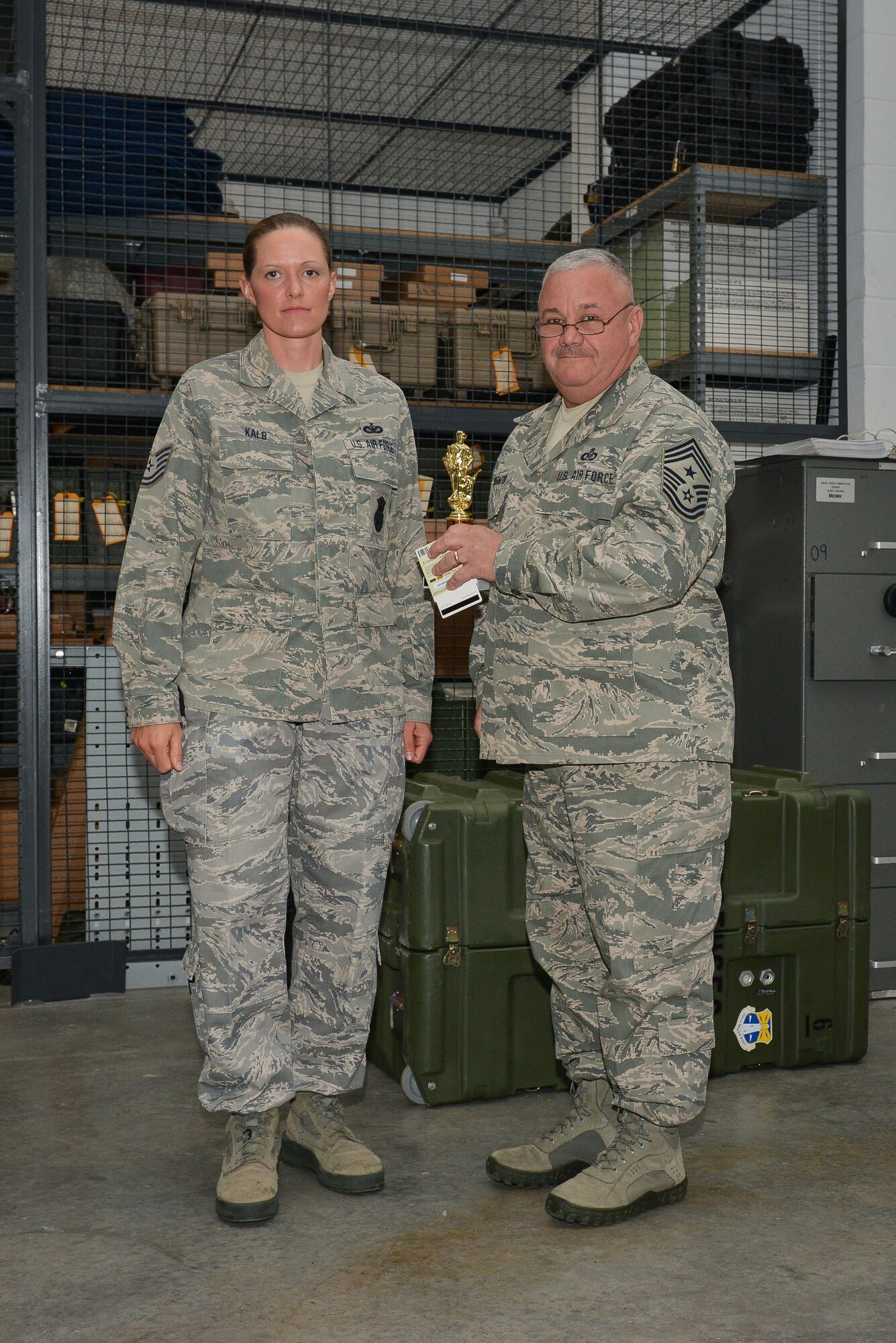 National Guard Tech. Sgt. Angela Kalb accepts the trophy for NCO of The Quarter, February 9, 2013 at Savannah Air National Guard Base in Garden City, Ga. Kalb is part of the 165th Airlift Wing Security Forces Squadron. (National Guard photo by Tech. Sgt. Charles Delano/released)